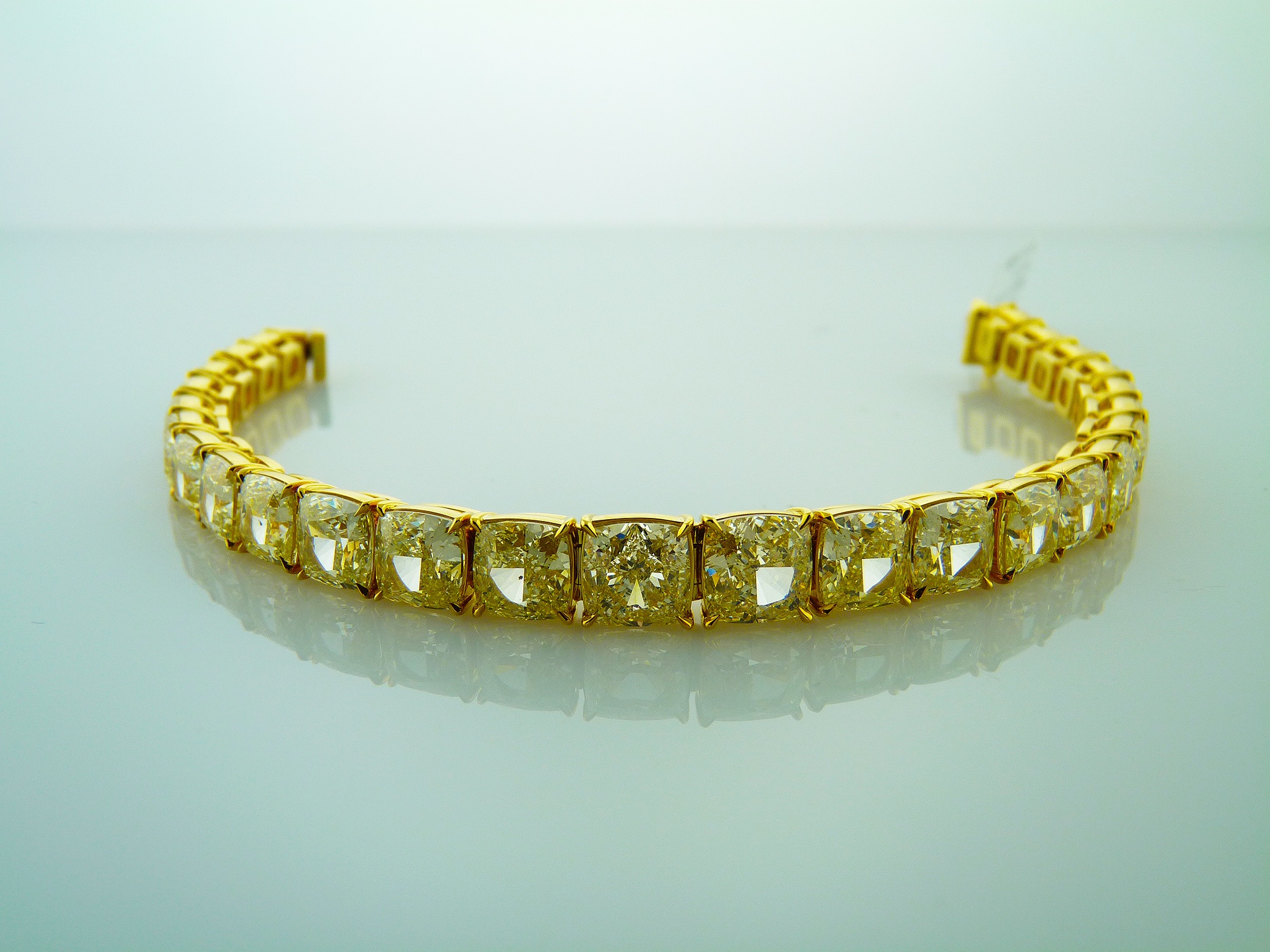 Natural Fancy Yellow Cushion Cut diamond tennis bracelet set in yellow gold