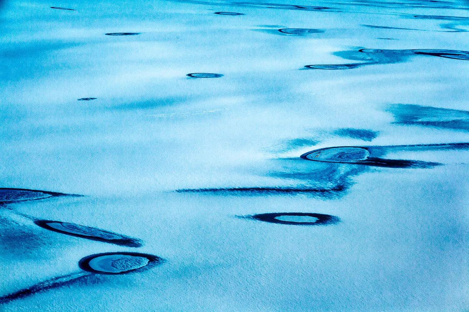 Aerial photography view of ice and water on the Greenland Ice Sheet.