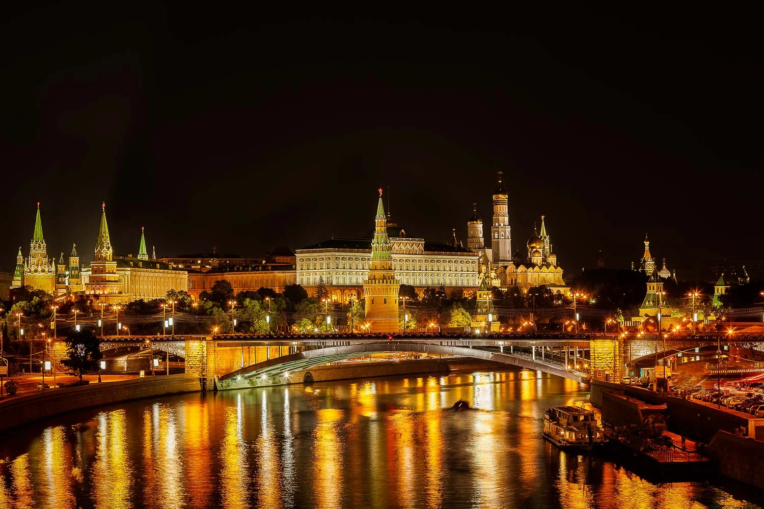 Landmark buildings reflected in the waters of the Moskva River on a summer evening in Moscow, Russia.