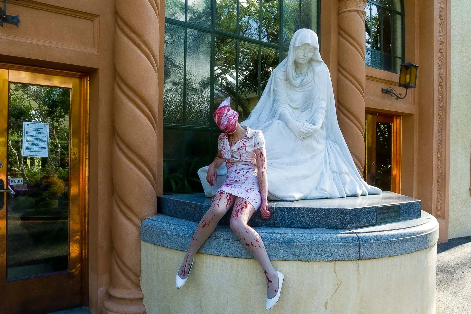 A zombie nurse resting outside the Conservatory in the Fitzroy Gardens , Melbourne .