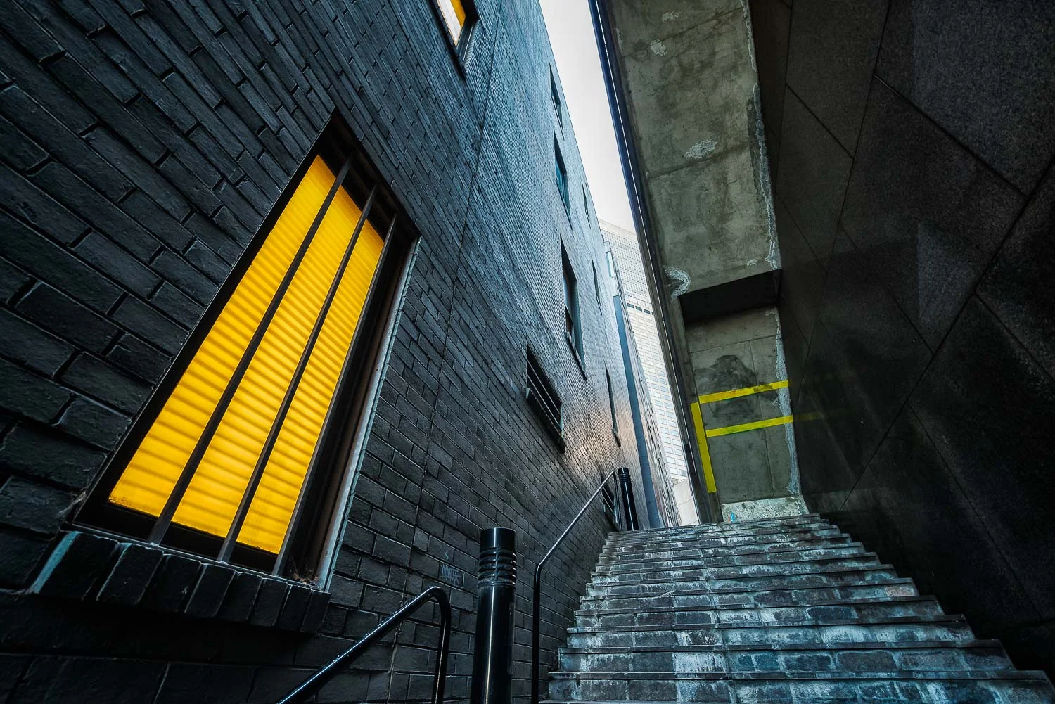 A steep staircase leads the visitor through a narrow alleyway in the City of Melbourne, Australia .