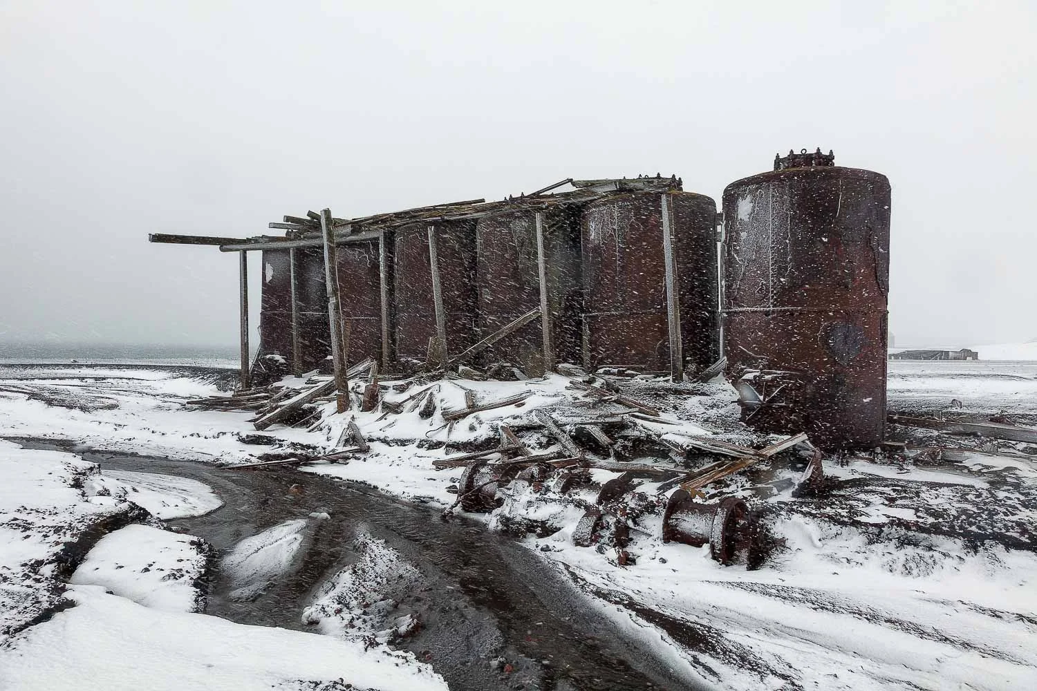 A group of old rusted oil drums at Port Foster on Deception Island , Antarctica