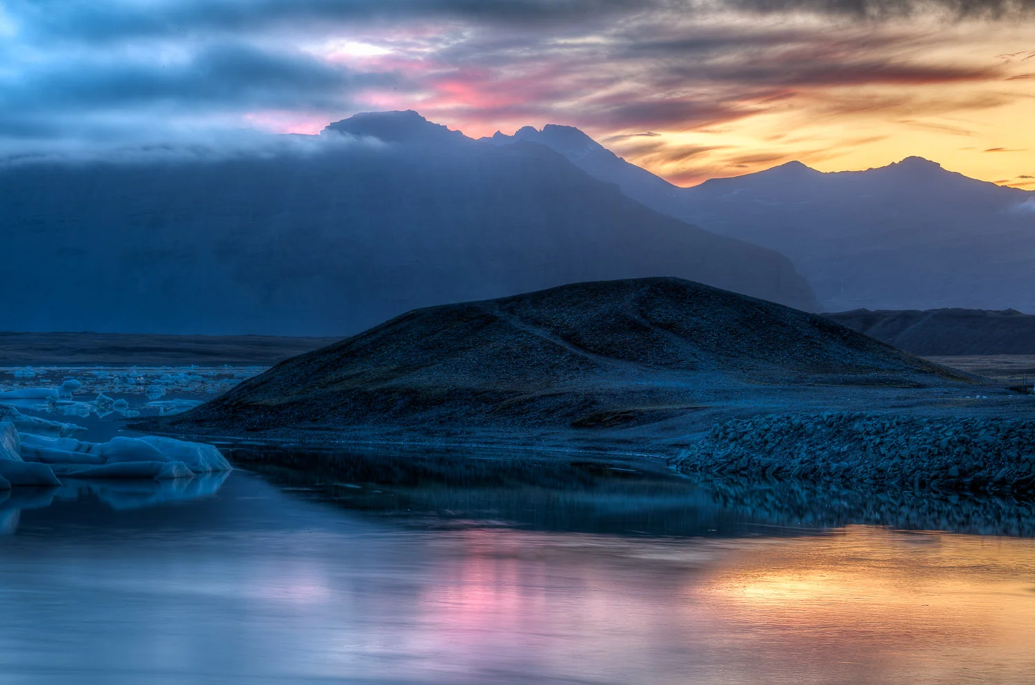 Beautiful sunset illuminating sky and water at Jökulsárlón Glacier Lagoon, Iceland.