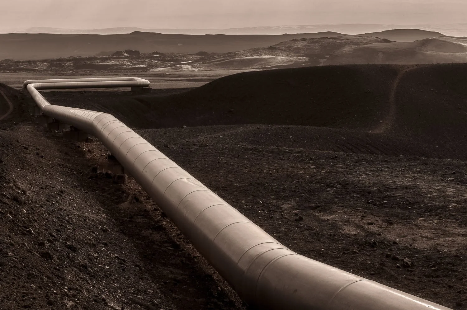 A large pipe transfers steam through the landscape near the Viki Crater not far from the town of Myvatn in Northern Iceland .