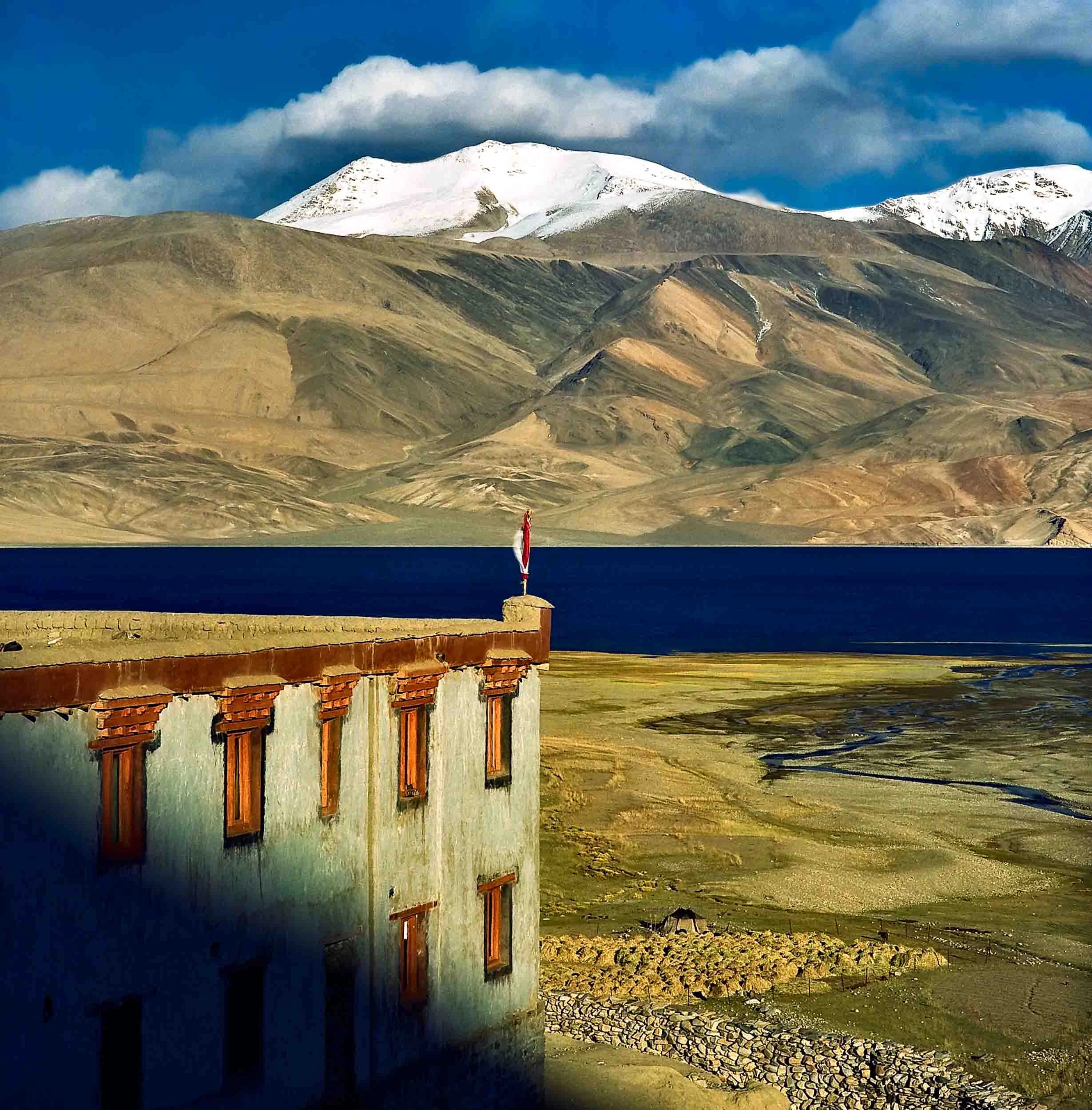 A beautiful Buddhist monastery in a spectacular landscape on the shores of Pangong Tso , Ladakh, India