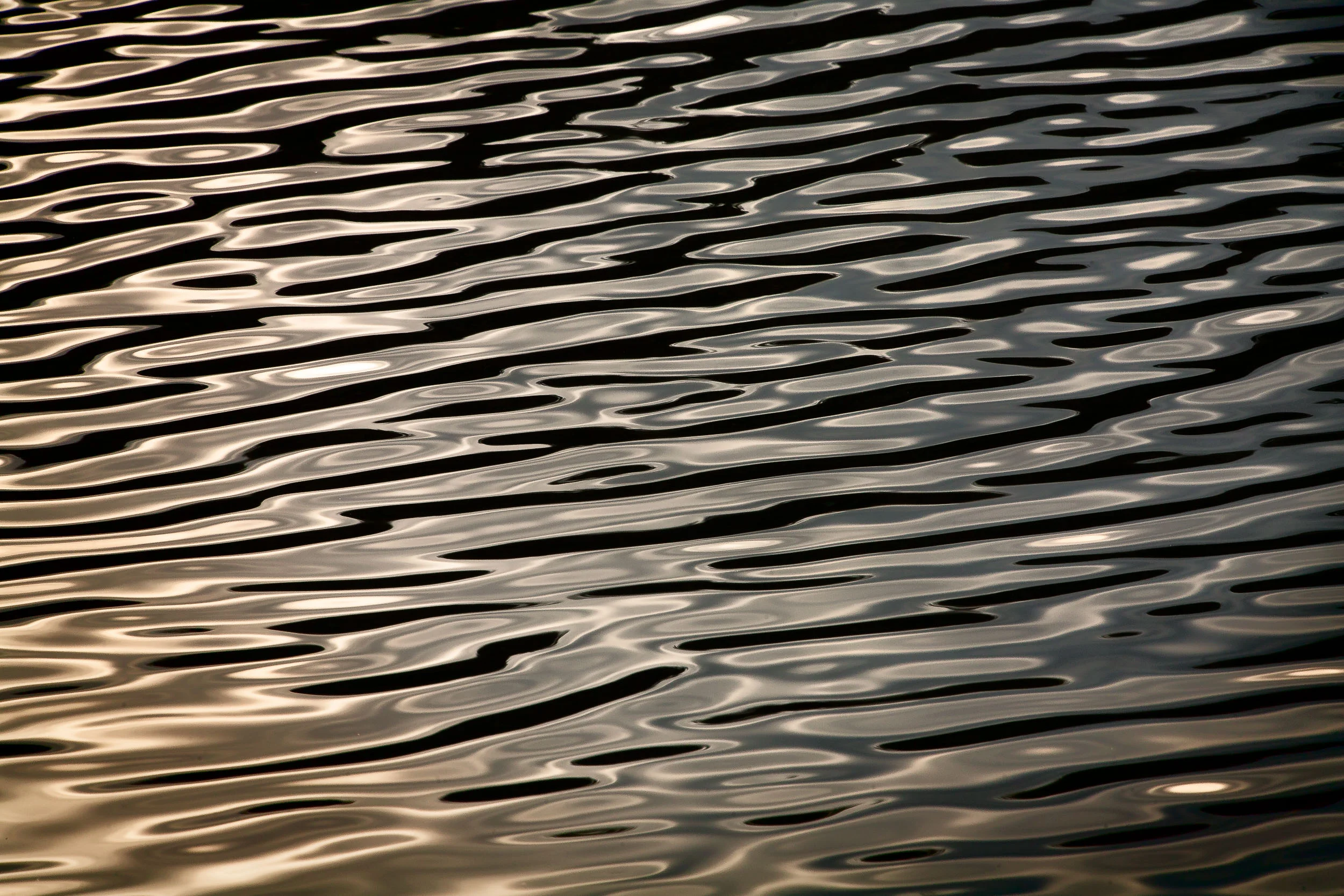 Abstract patterns on the surface of Expeditions Pass Reservoir near Chewton in Central Victoria, Australia.