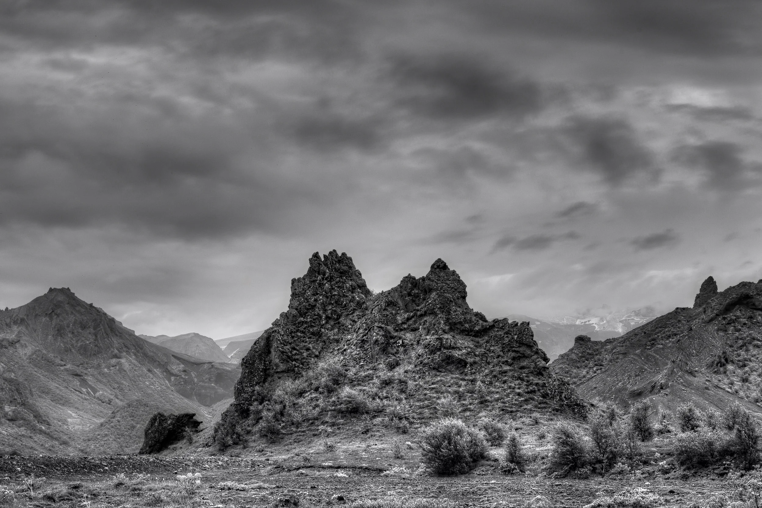 A black and white photo depicting the rugged beauty of the Highlands in central Iceland .