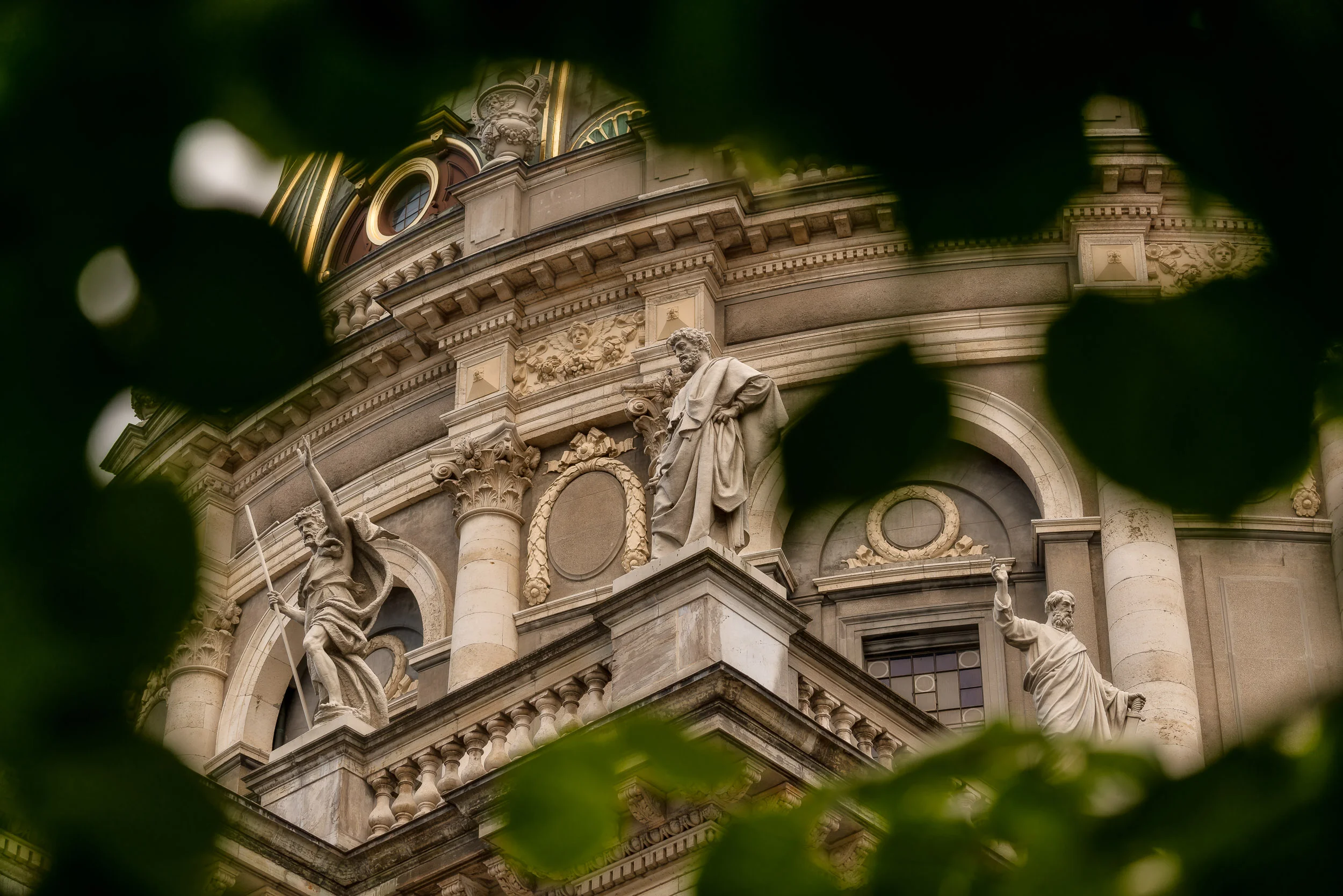 The notion of a frame within a frame is used to compose this unique image of statues perched around the beautiful Frederiks Church in Copenhagen, Denmark .