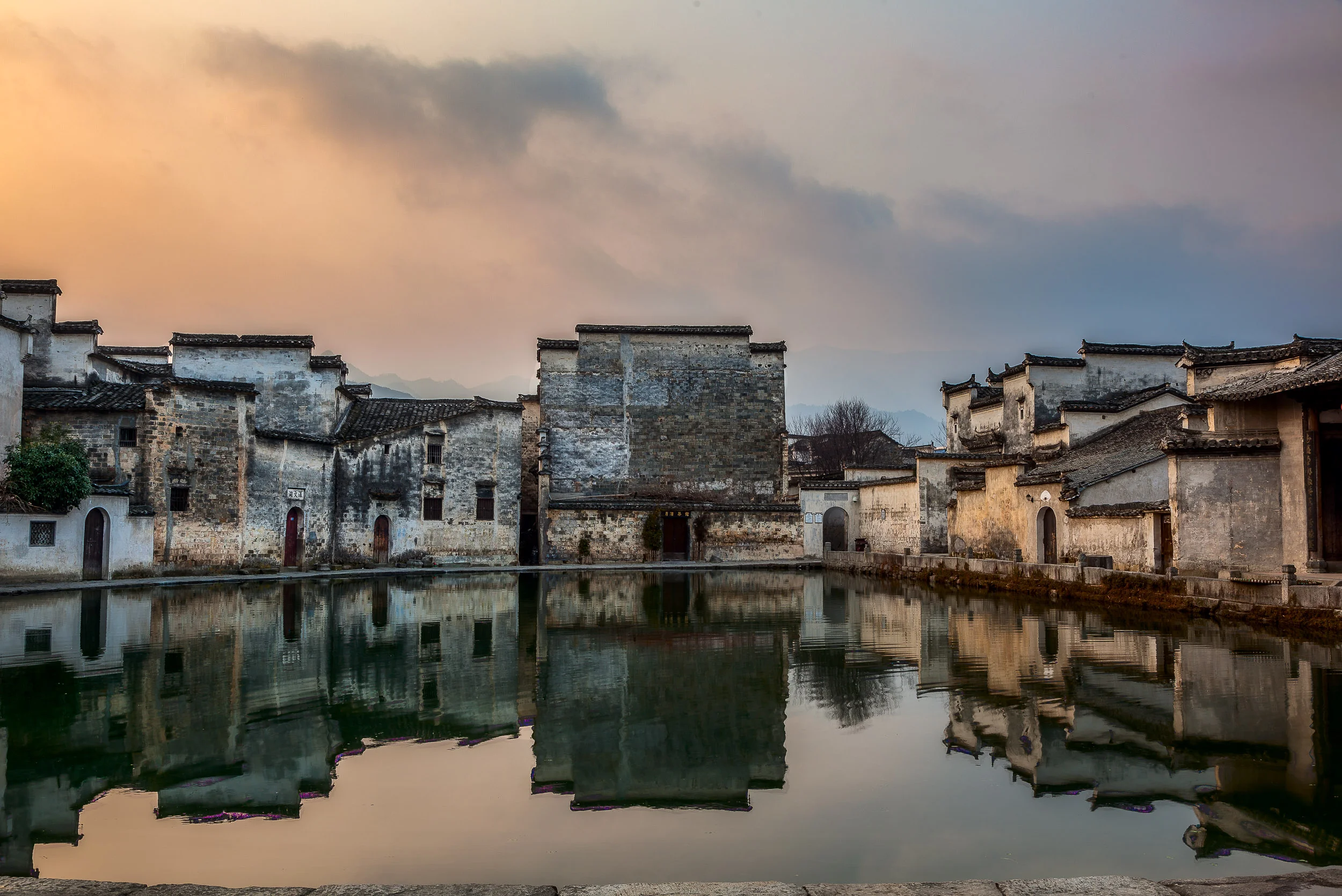The pond surrounded by houses in the centre of the idyllic village of Hongcun in Anhui Province, China .