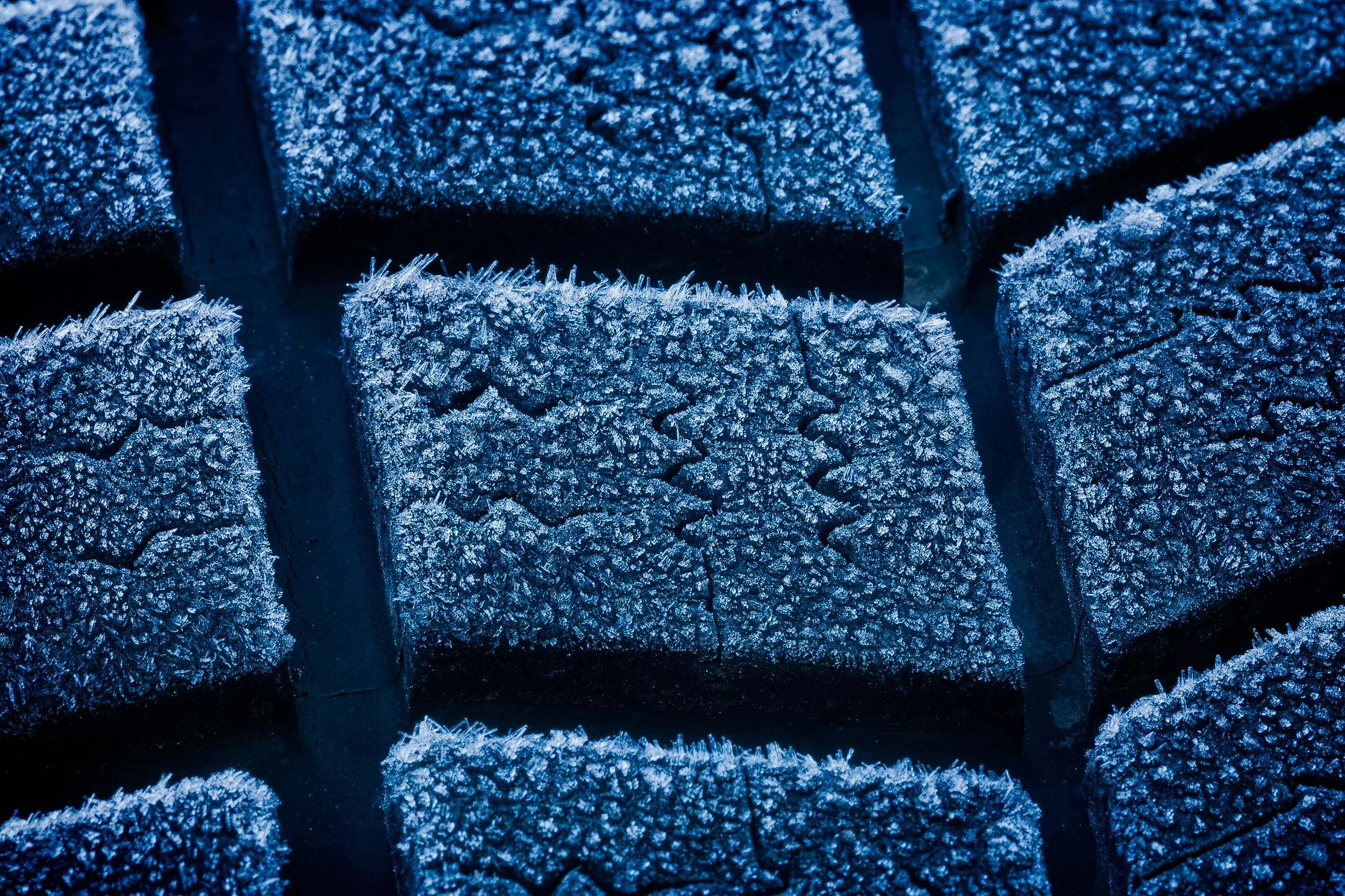 A close up of frost on a car tyre provides perfect subject matter for an exploration into the world of abstraction .