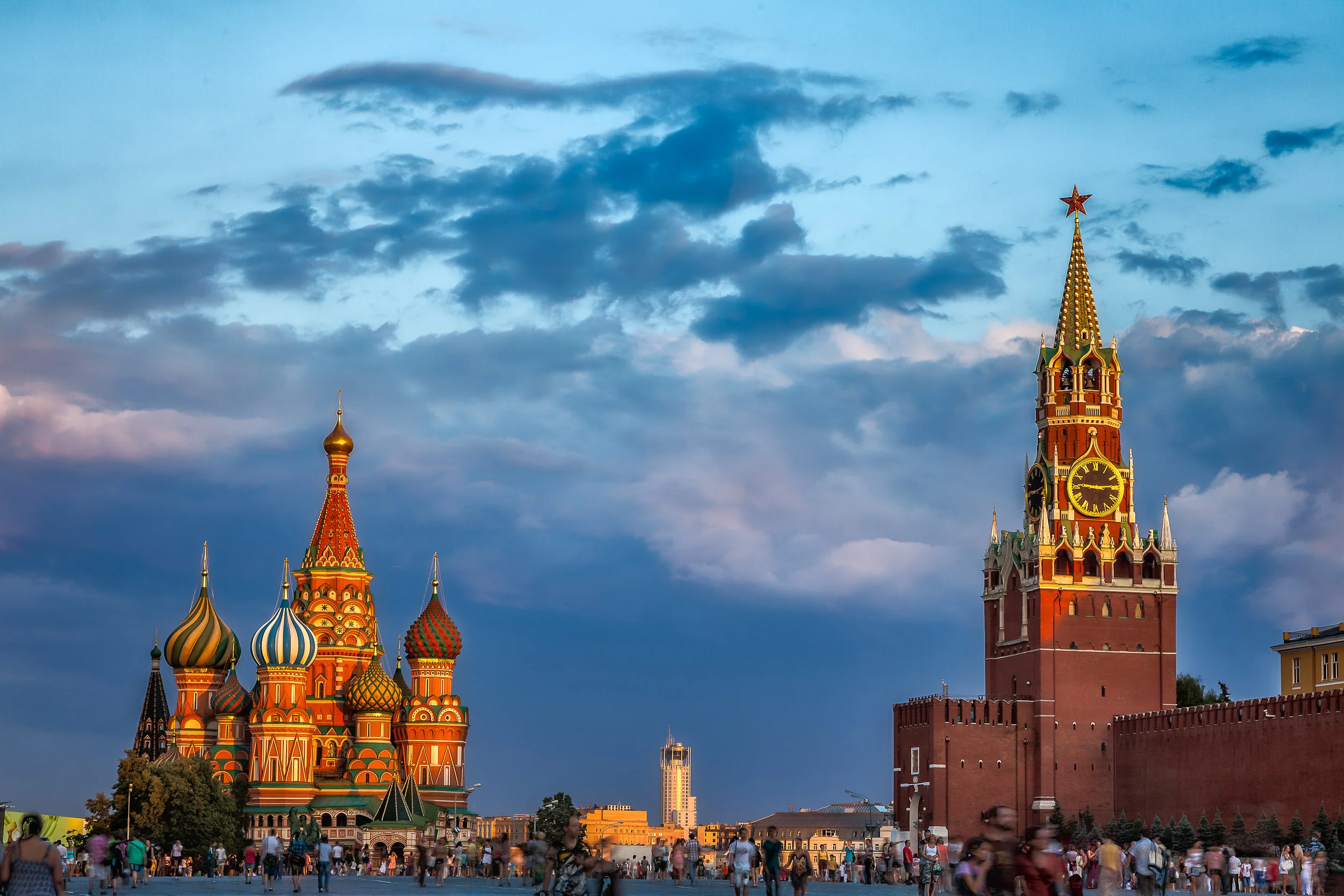 Warm sunset light illuminates the Kremlin and St. Basil's Cathedral in Red Square, Moscow .