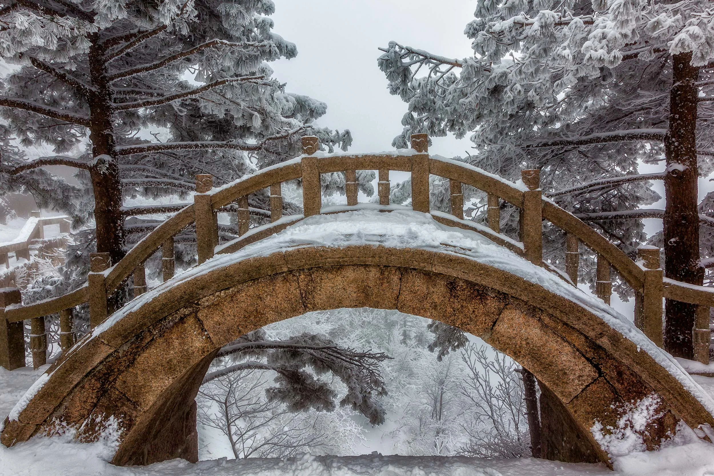 Color and shape underpin this classic bridge on Huangshan in China .