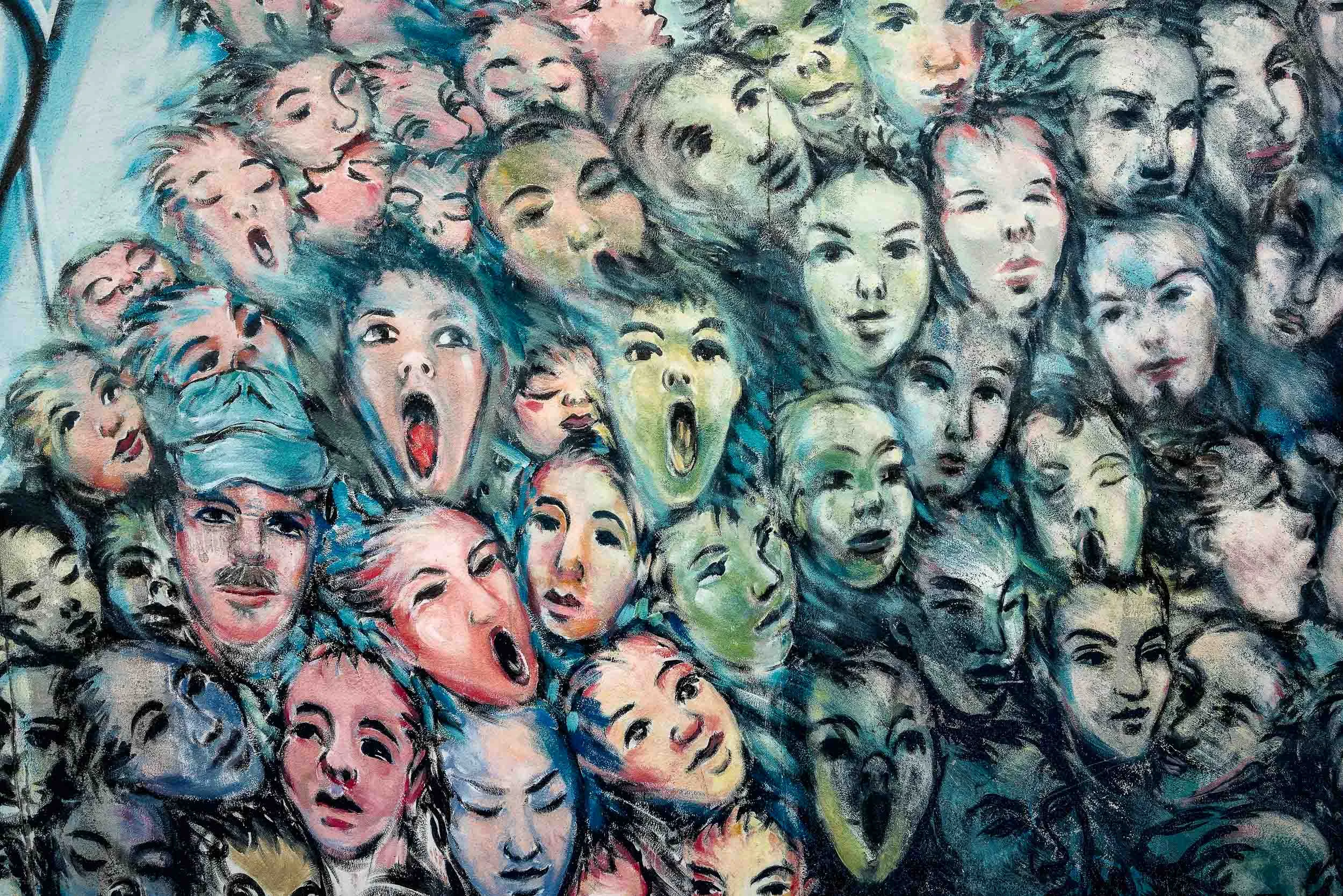 This excellent example of street art at the East Side Gallery in Berlin, Germany is a painting by Kani Alavi, an Iranian born artist depicting people breaking through the wall.