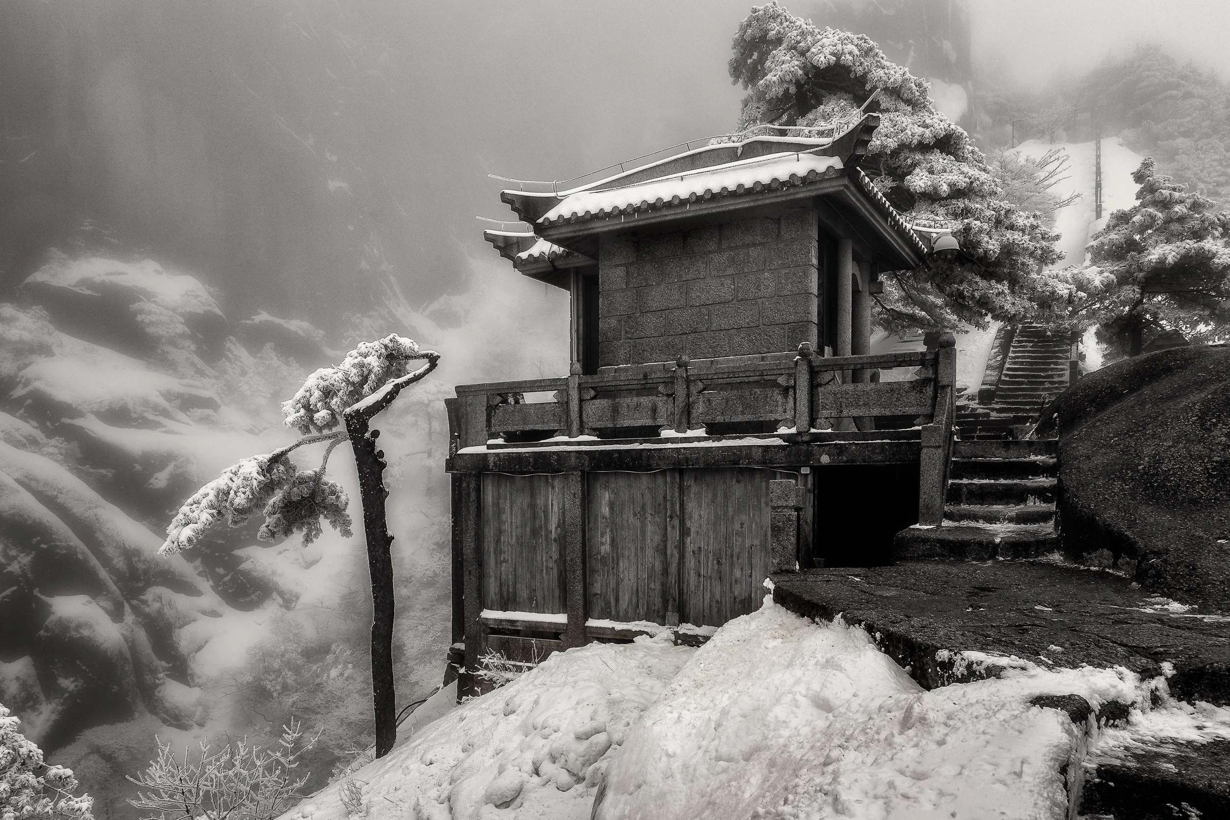 A rest stop for travelers near the top of a high, windswept pass on Huangshan (i.e., Yellow Mountain) in China .