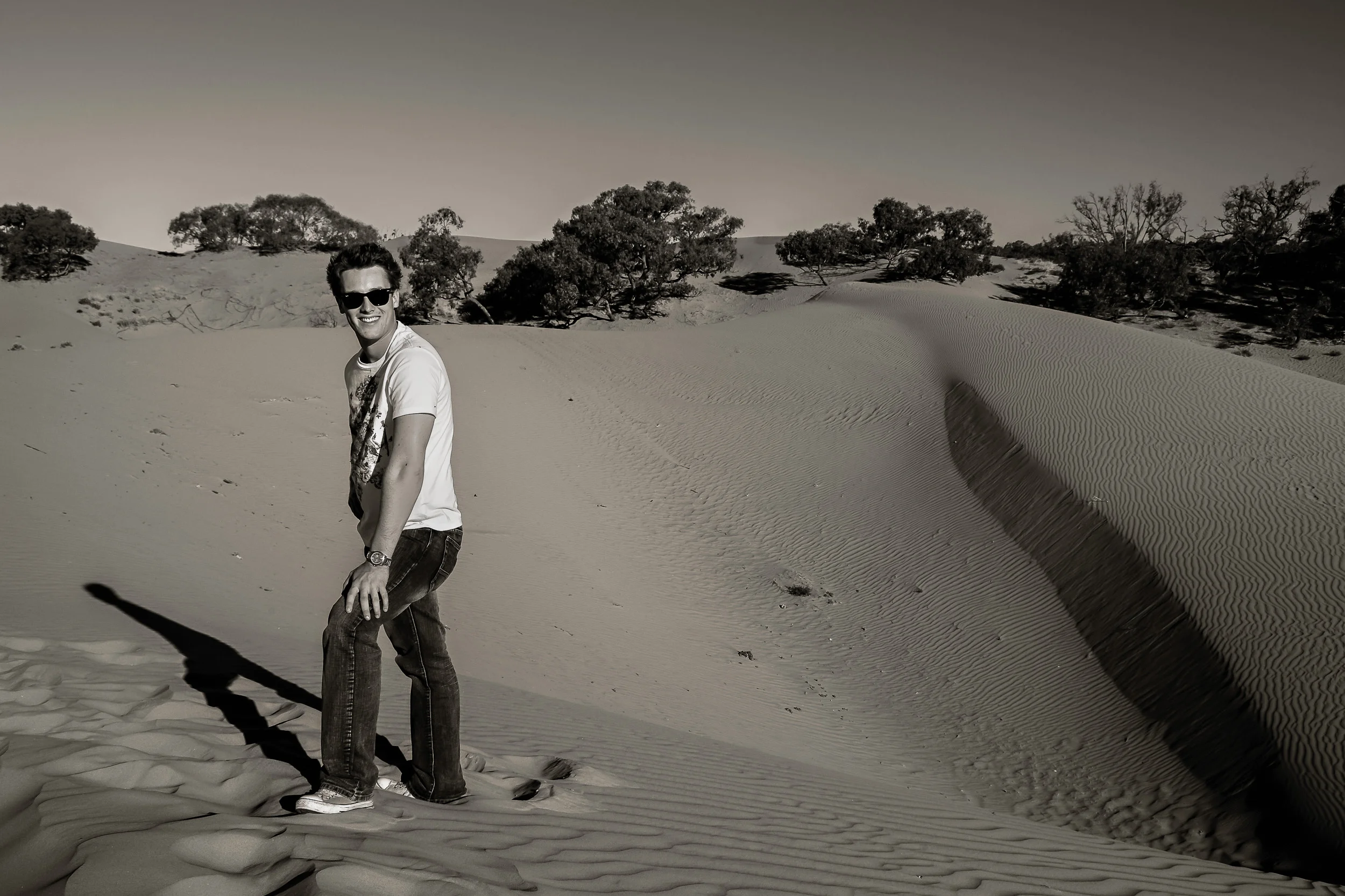 Guitarist and teacher Patrick David Gray amonst the long shadows and soft light at the Perry Sandhills in NSW, Australia .