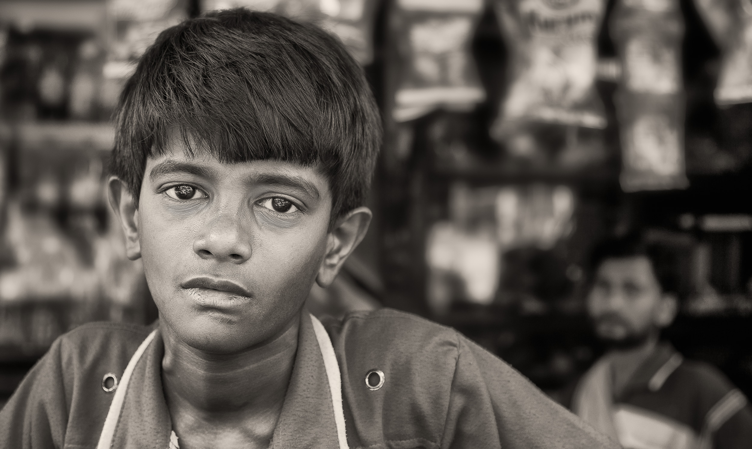 Poigent street photos like this portrait of a young boy in Kolkata.