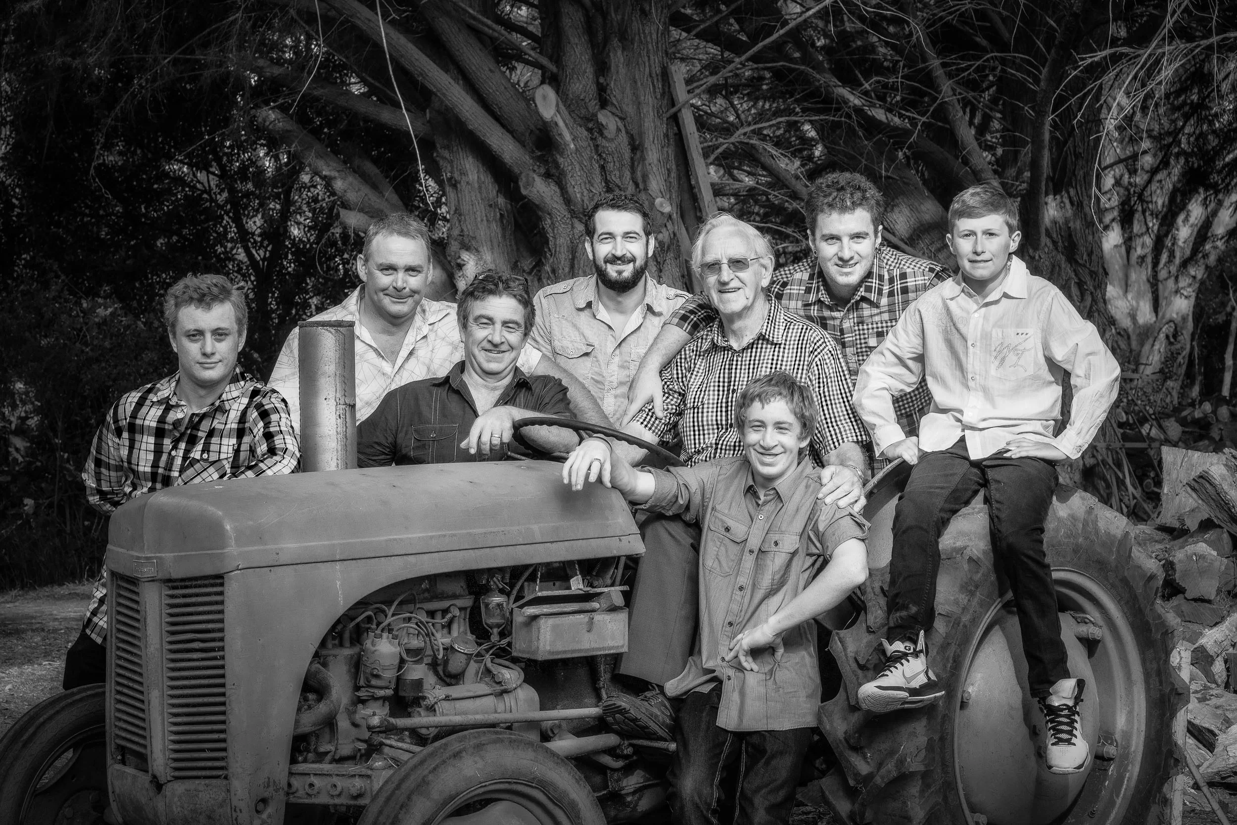 A group photograph featuring three generations of men on a tractor in Hamilton, Australia .