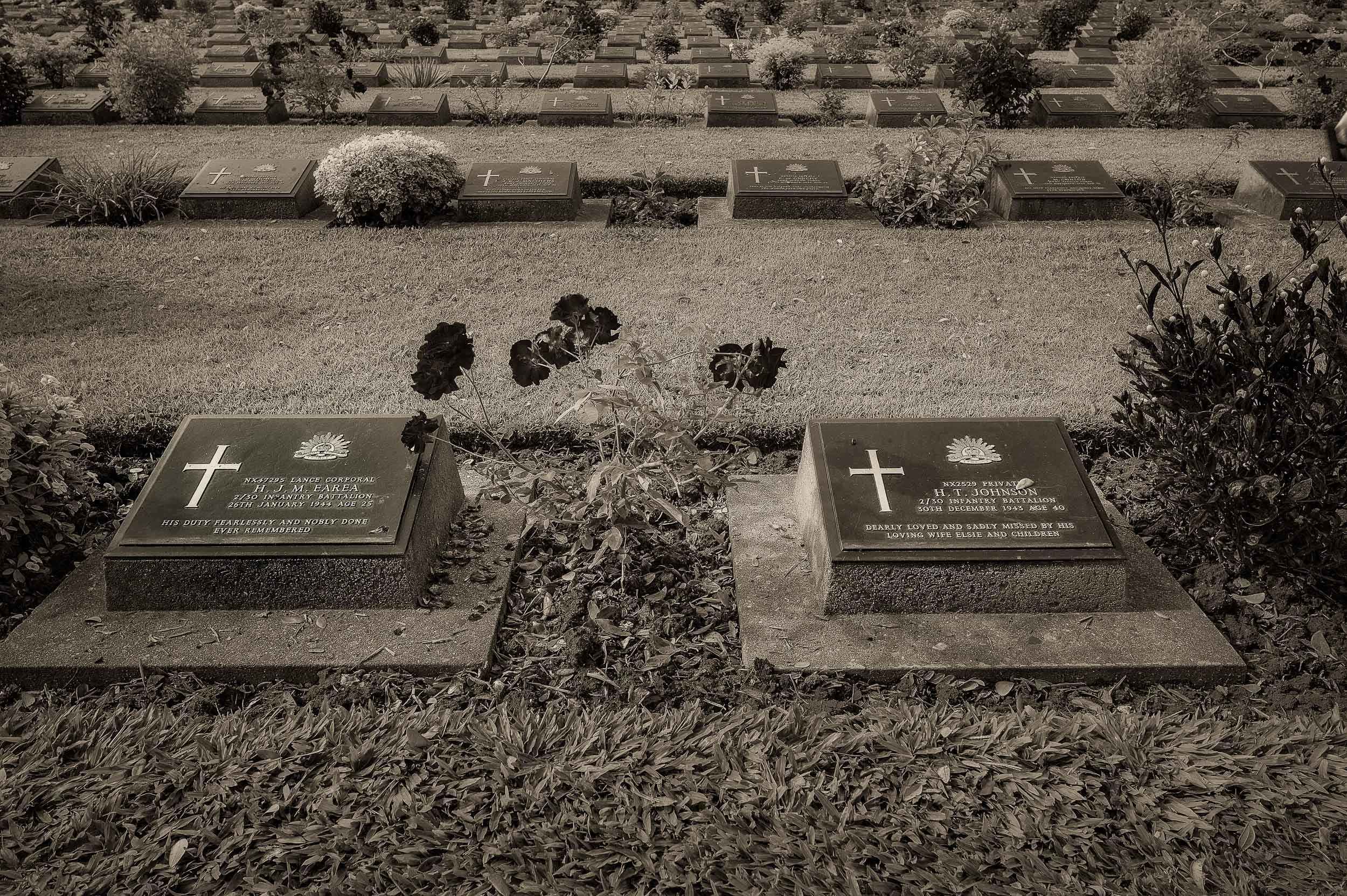 Grave stones at the beautifully maintained Kanchanaburi War Cemetery in the town of Kanchanaburi, Thailand .