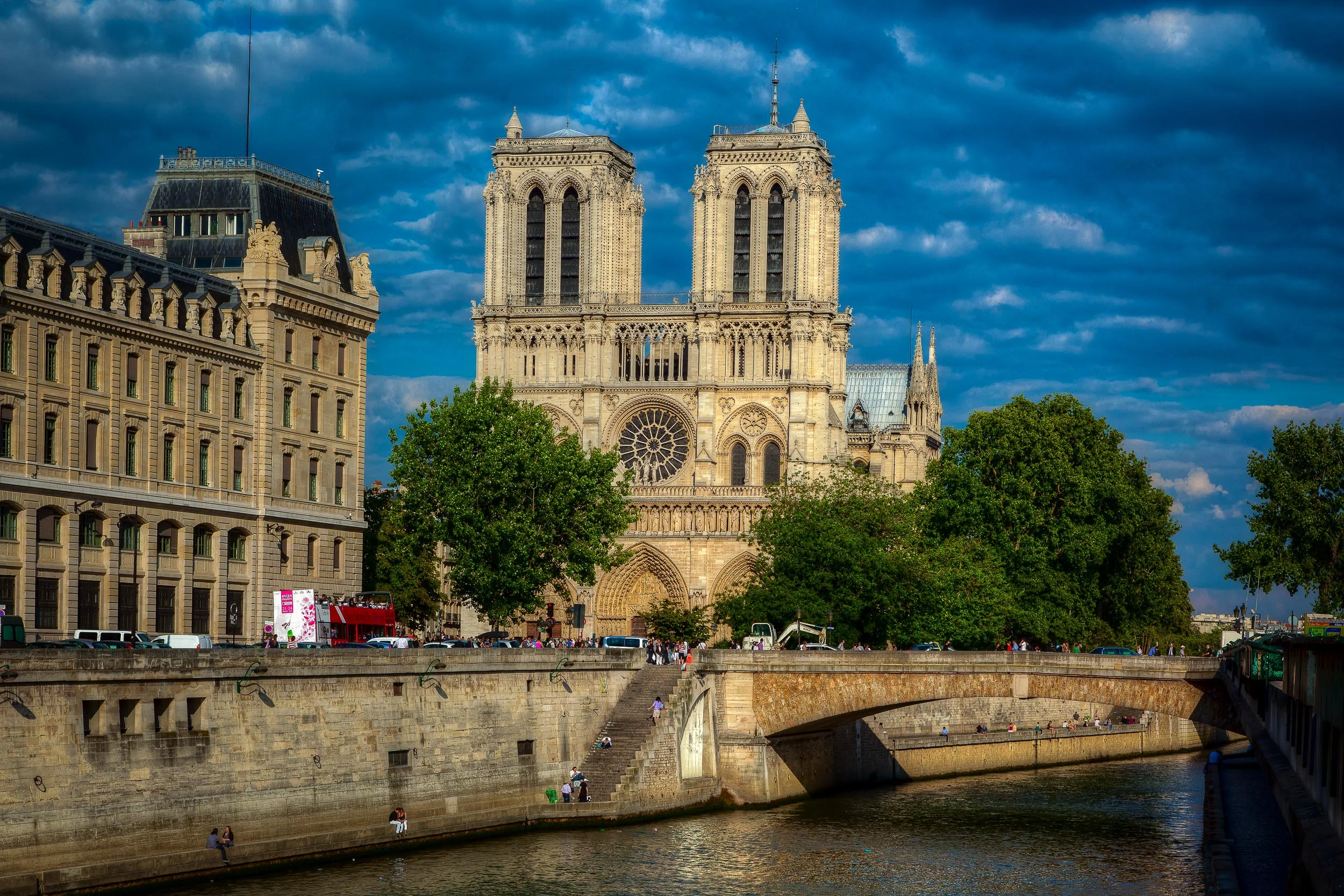 A sunny day view of Notre Dame Cathedral and the River Seine in Paris, France .