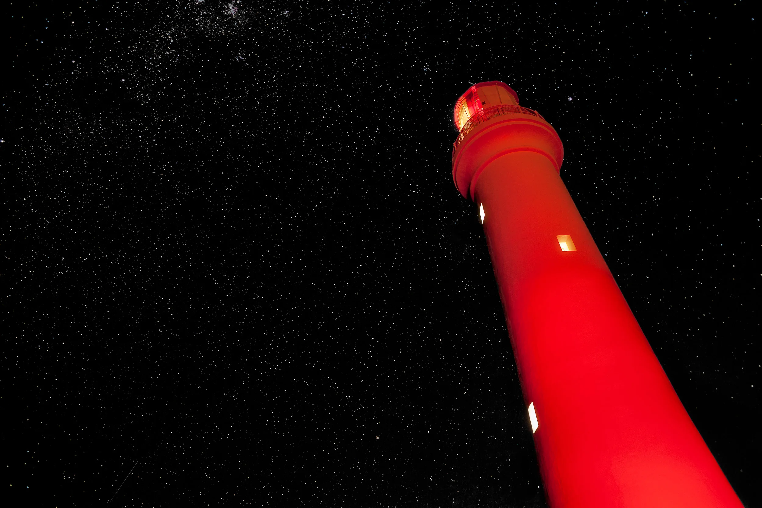 Red light illuminates the Split Point Lighthouse at Aireys Inlet along the Great Ocean Road in Australia .