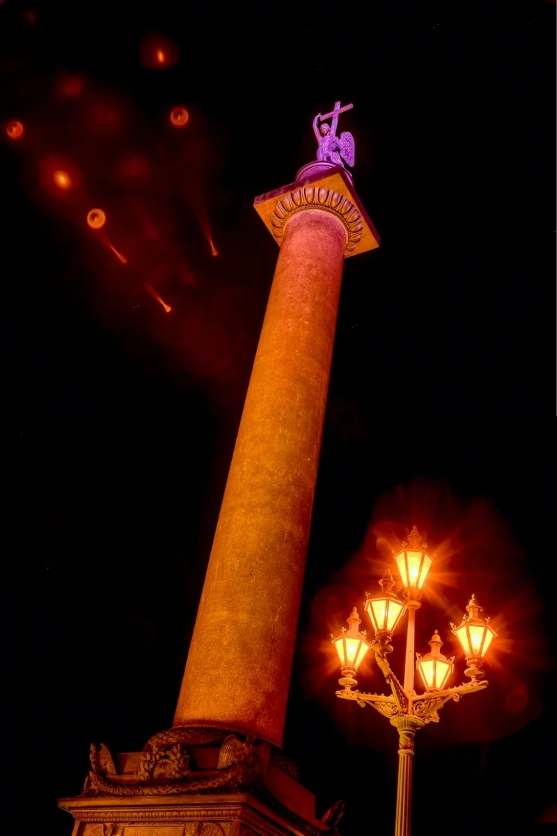 The spectacular Alexander Column , illuminated at night, at Palace Square in St. Petersburg, Russia.