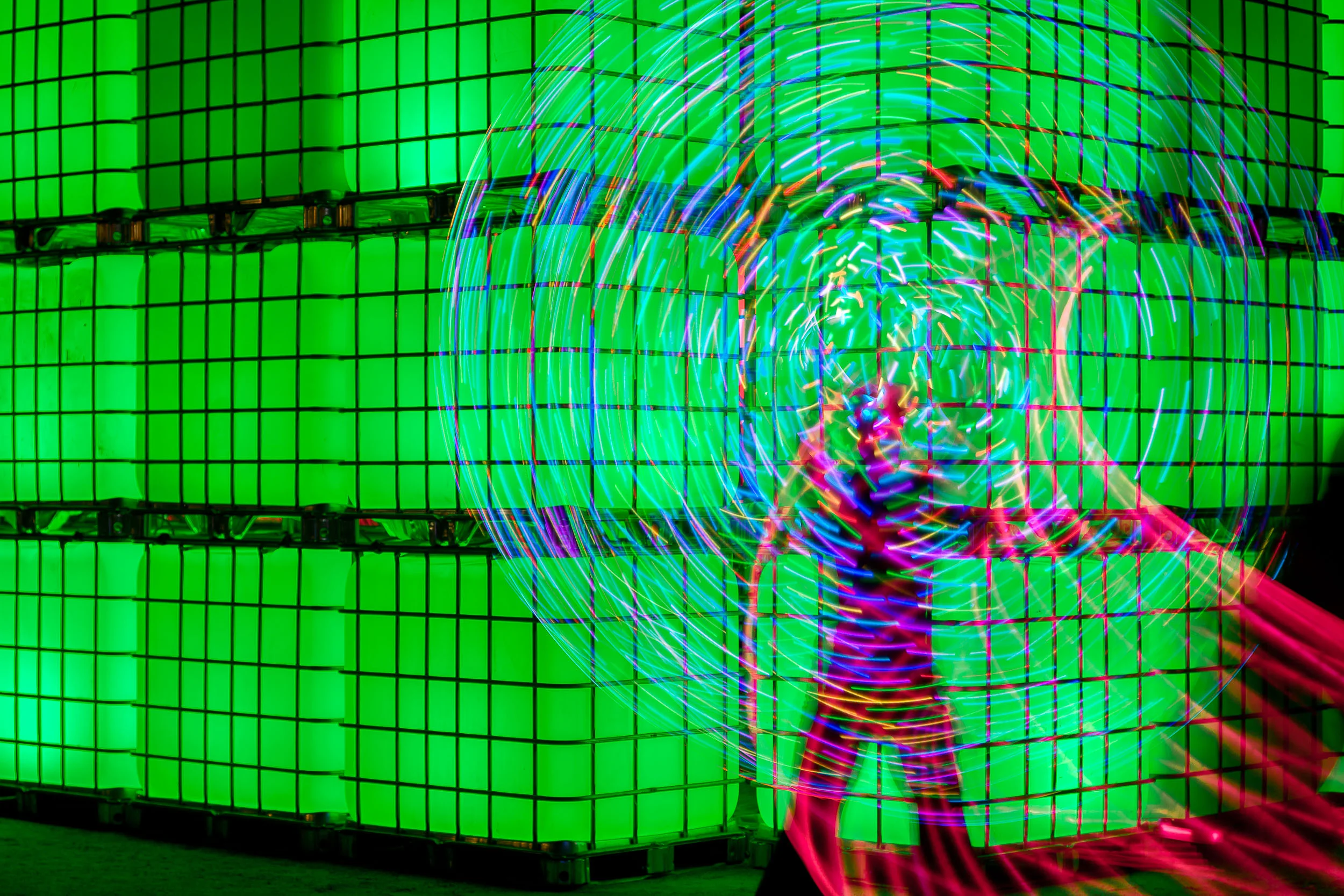 A performance artist twirls light sticks in front of an installation at Birrarung Marr in Melbourne , Australia.