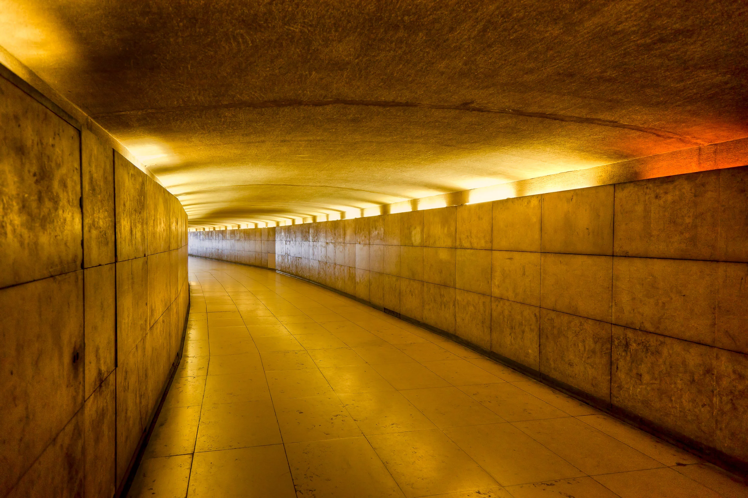 Warm artificial light illuminates a subway in Paris, France