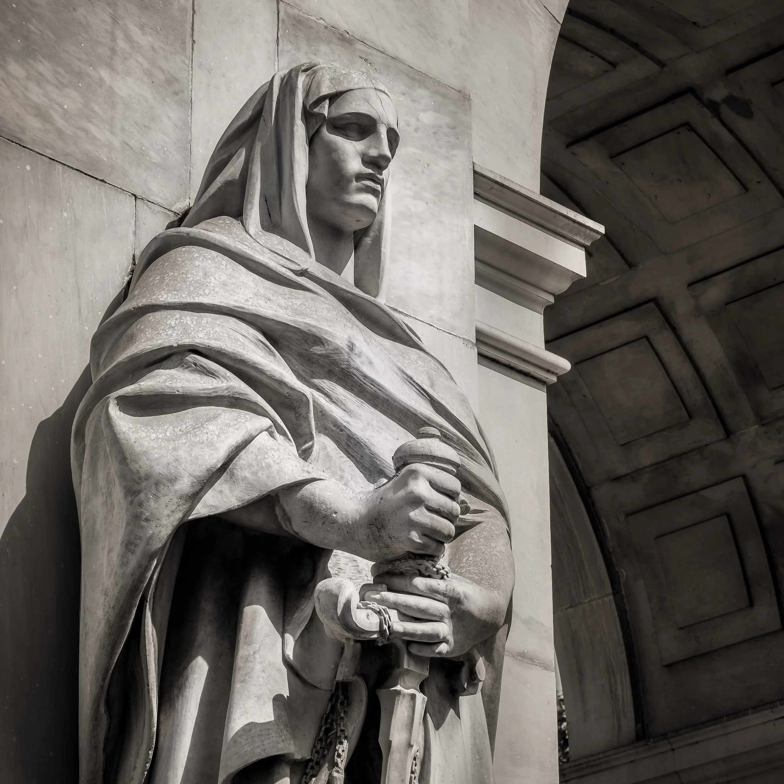 A stone statue appears to stand guard outside the magnificent Victoria Memorial in Kolkata, India .