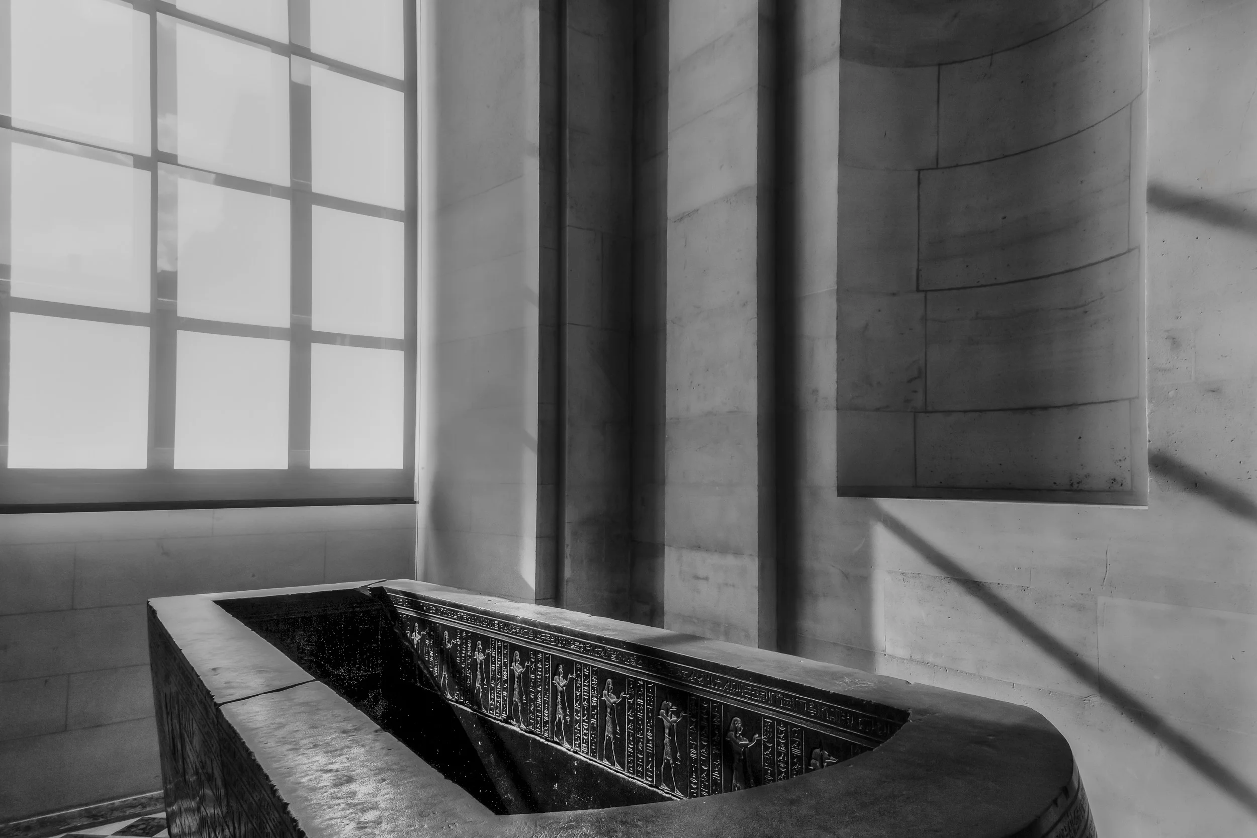 Dynamic shapes and shadows providing the perfect setting for this Egyptian Sarcophagus within the Louvre in Paris, France