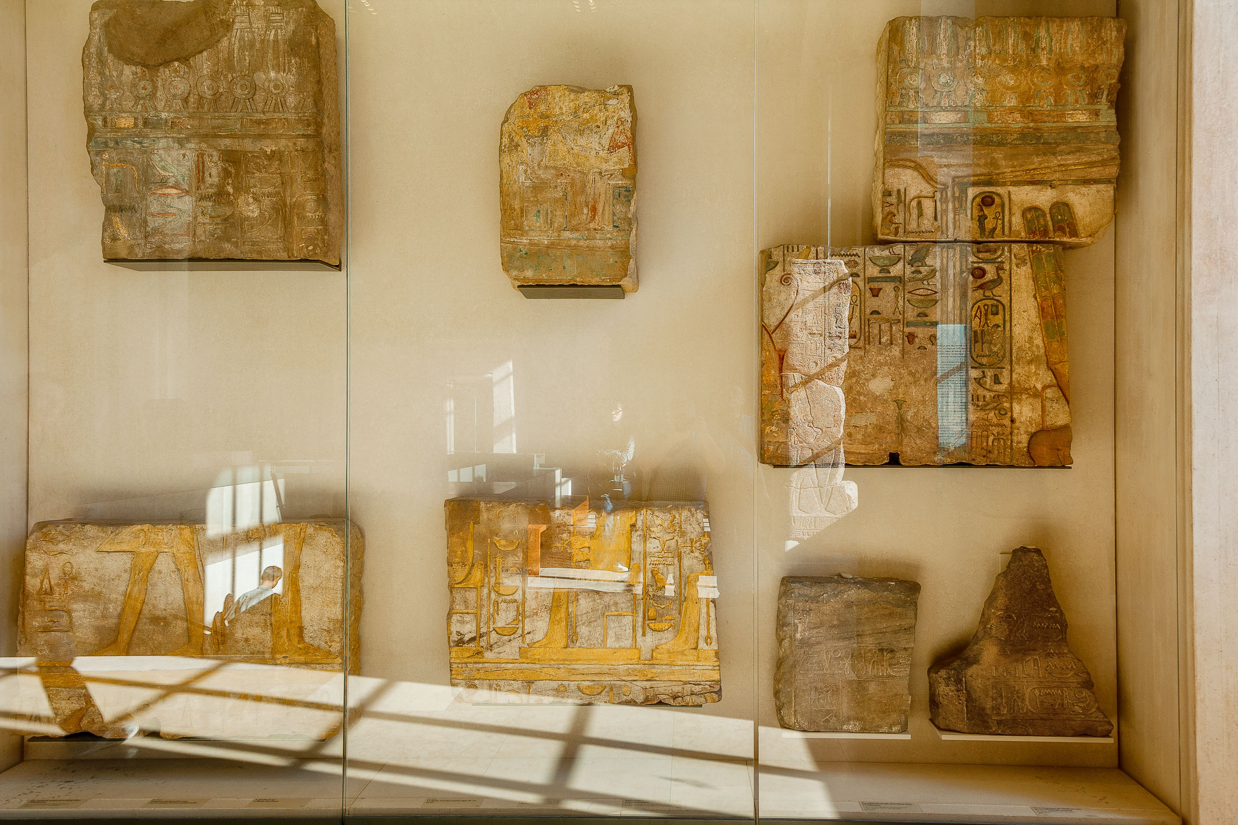 A display case showcasing stone tablets at the Louvre in Paris, France .