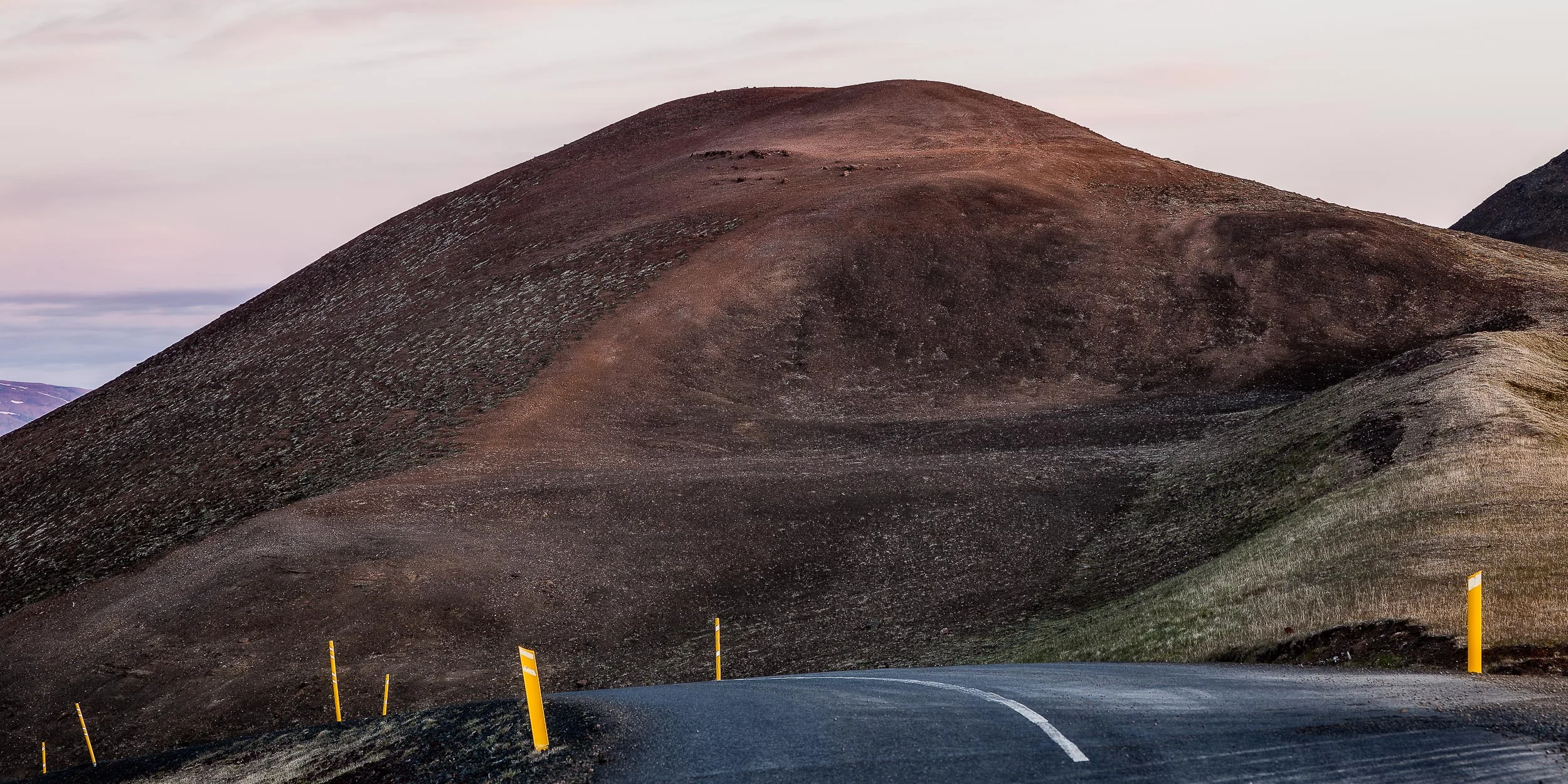 A spectacular drive , along a sealed road, at the top of a mountain pass near Myvatn in northern Iceland .
