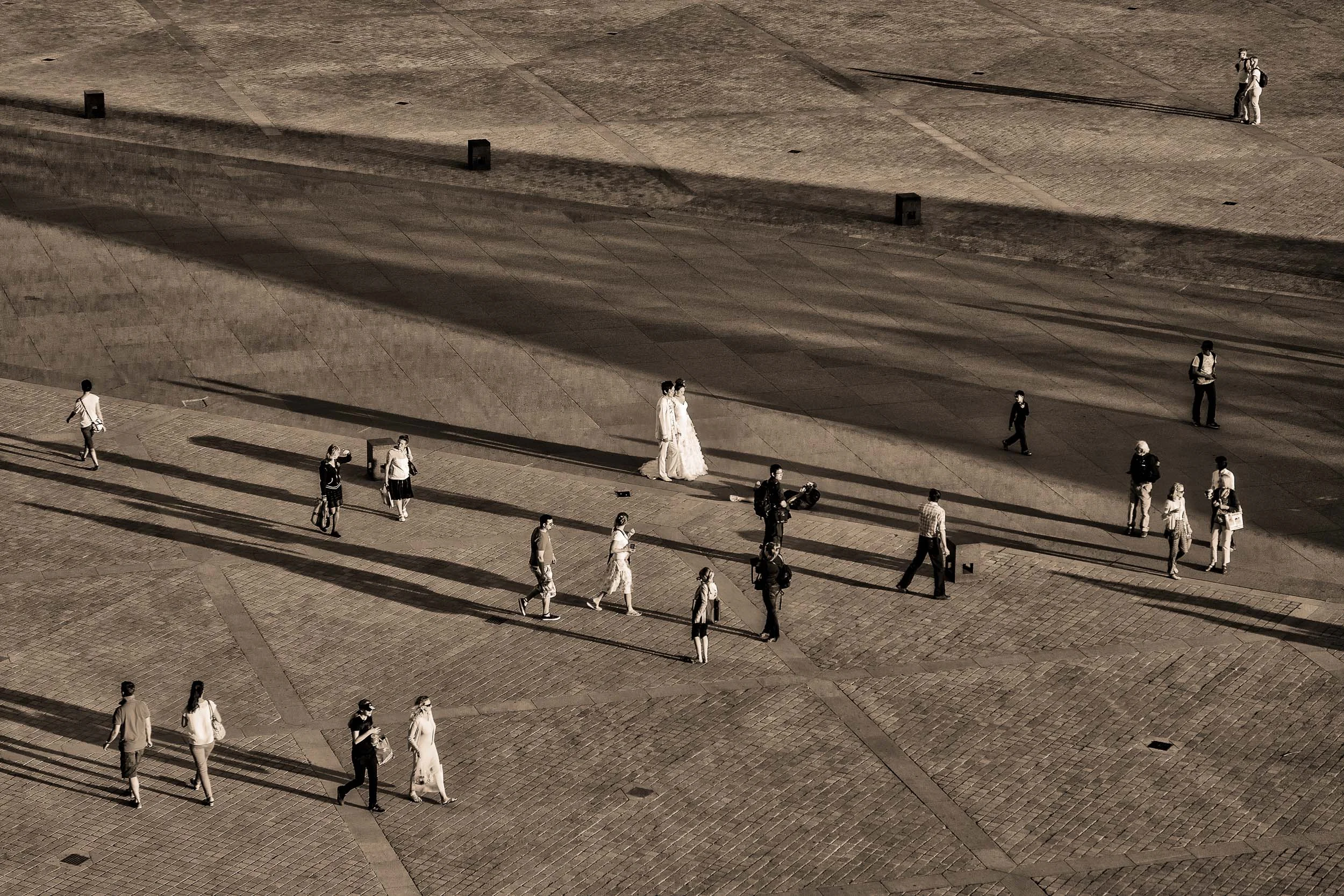 A candid image of a bride and groom being photographed in Paris, France .
