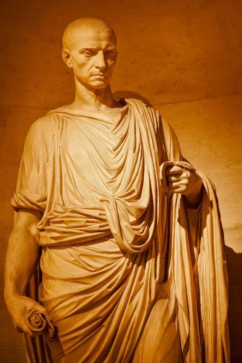 A statue , illuminated by artifiical light, in the Musée du Louvre, Paris .