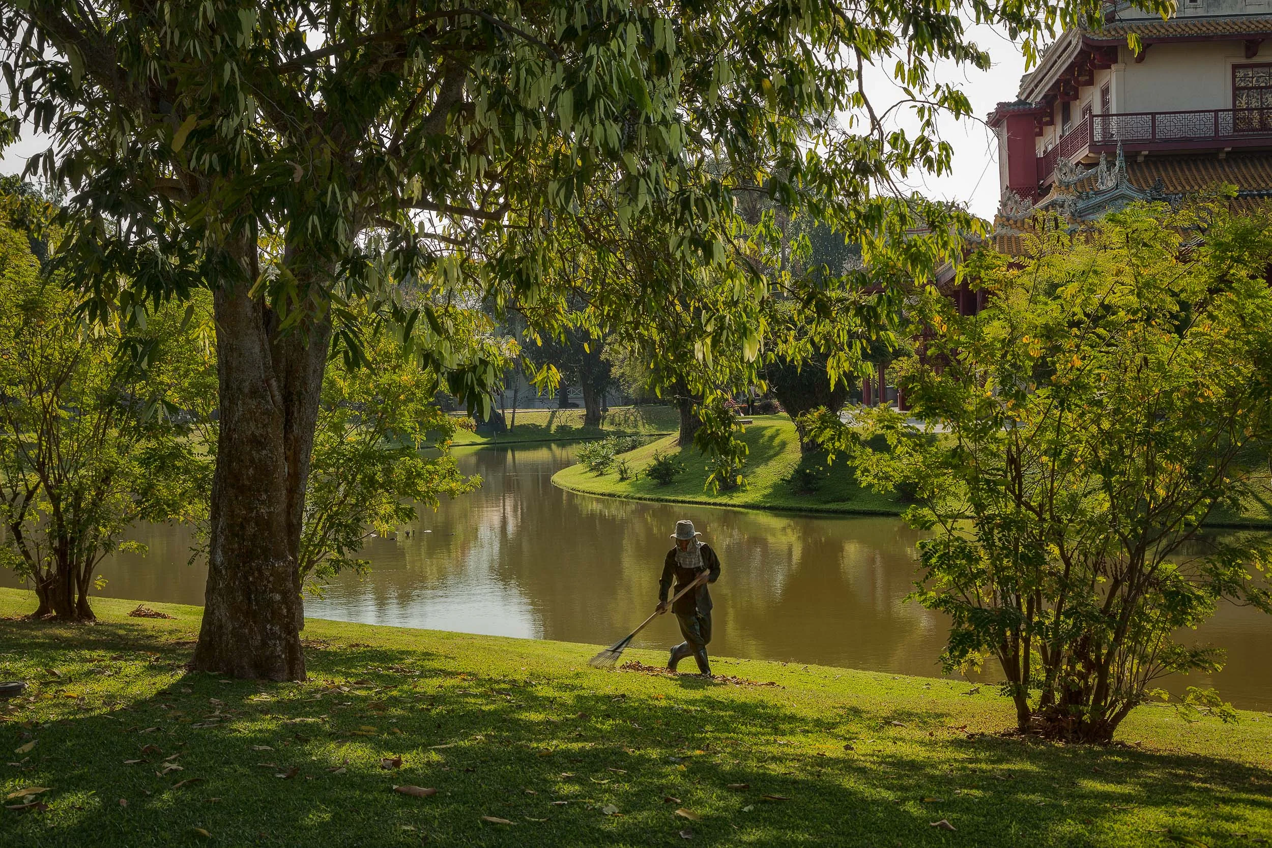 A worker raking the lush lawns at Bang Pa In near Ayutthaya, Thailand.