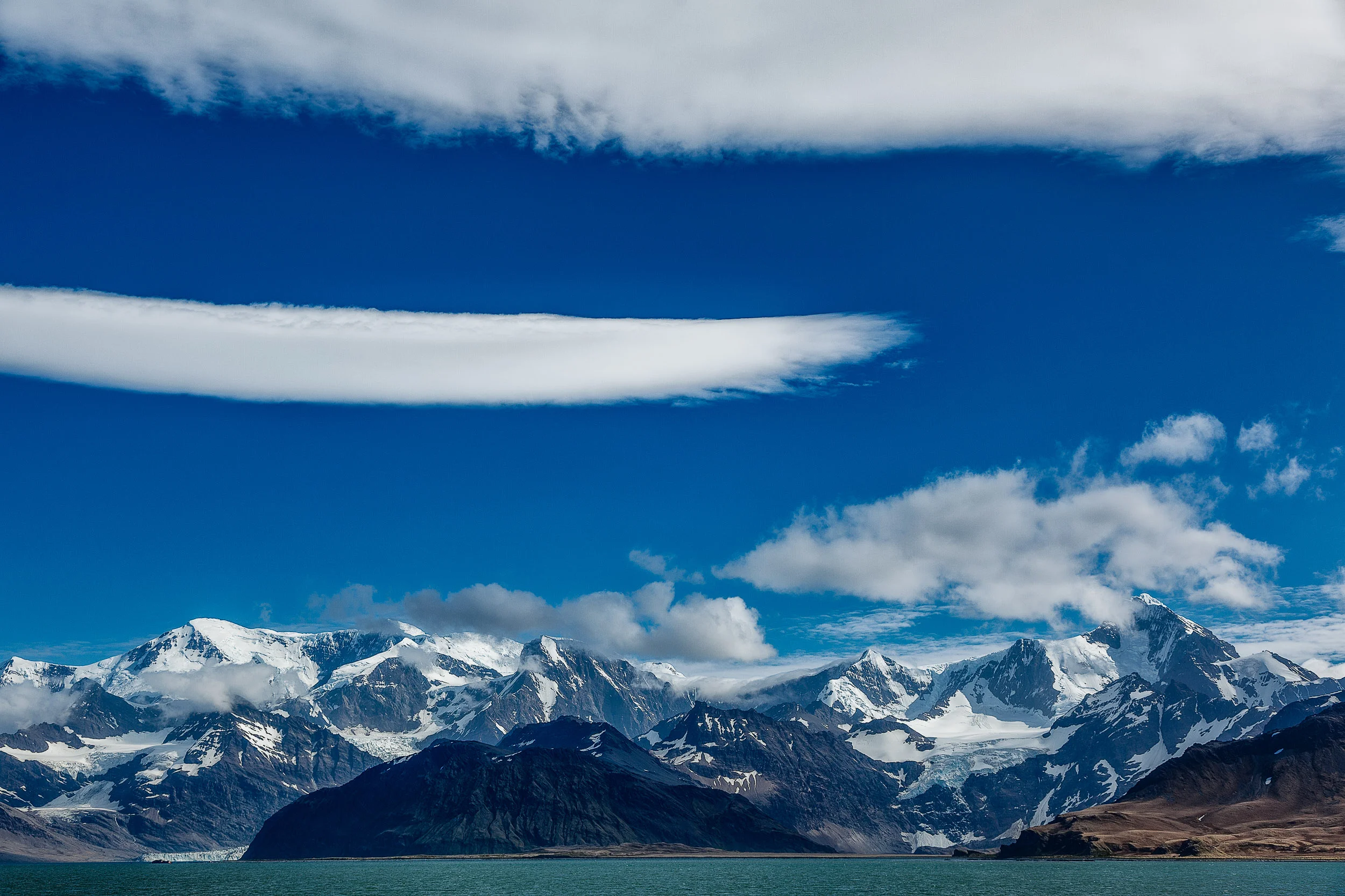 Looking back towards a magnificent skyscape above South Georgia Island in the South Atlantic Ocean .