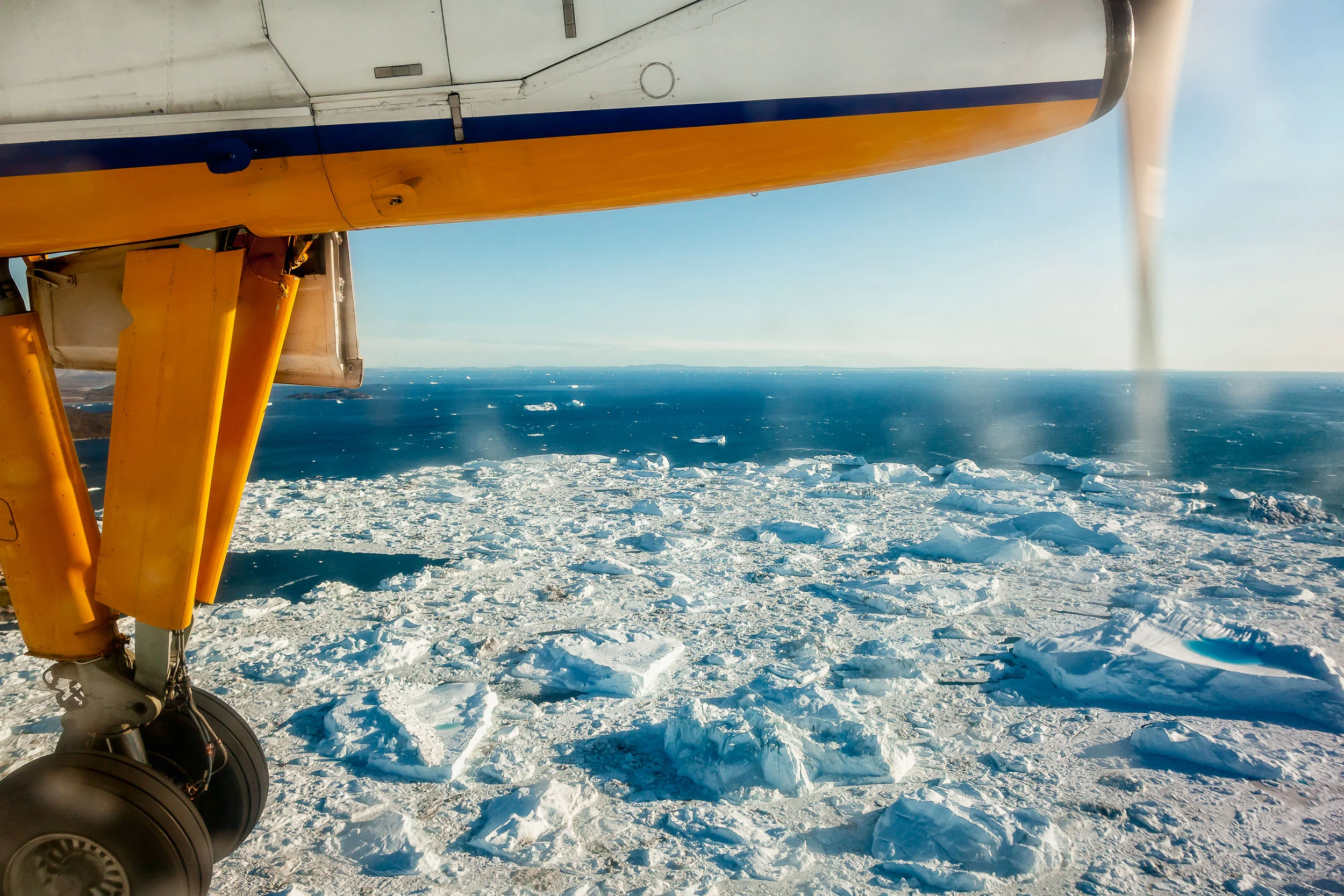 The wild beauty of Greenland seen through my plane window just before landing in Ilulissat, Greenland .