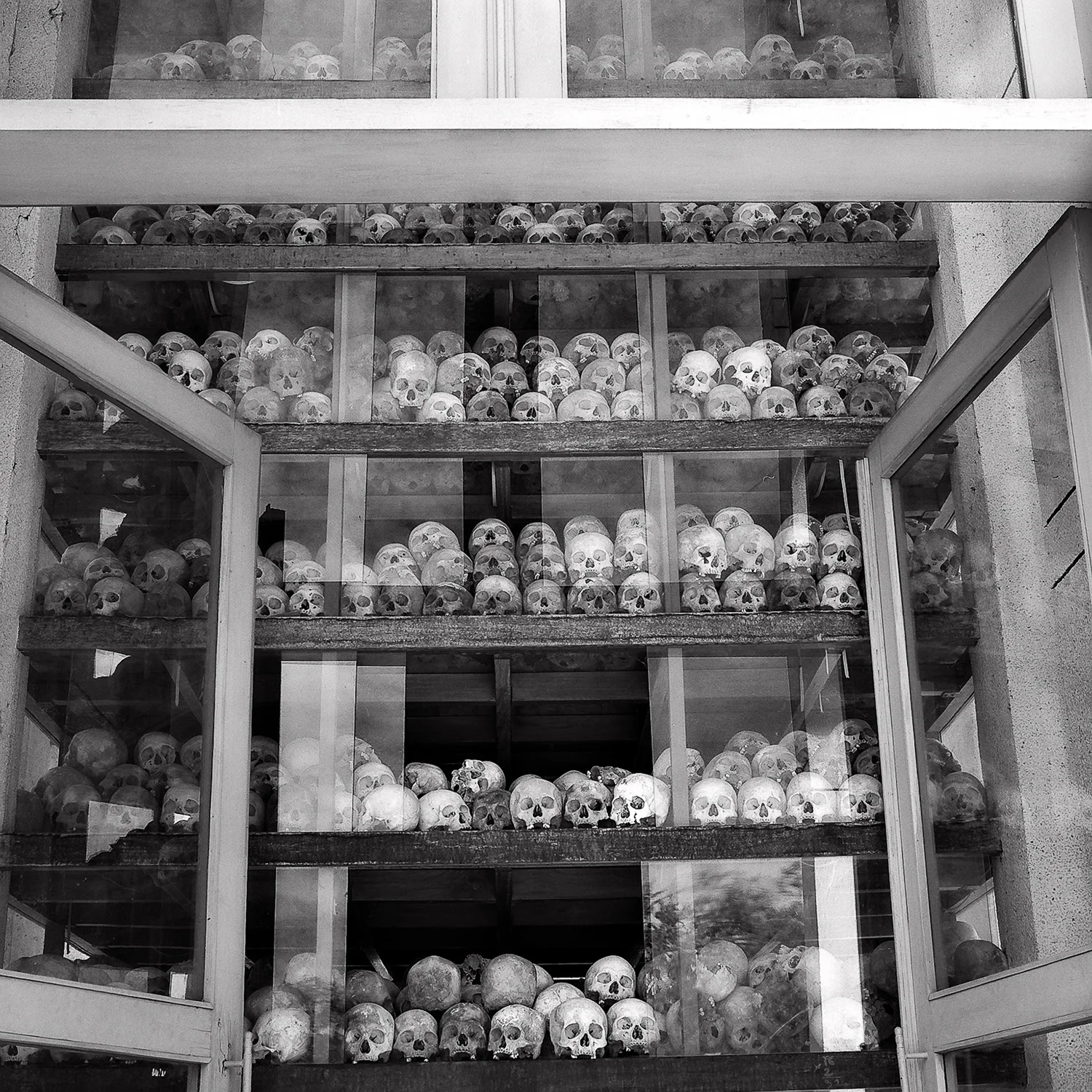 A shrine, full of skulls , at the Killing Fields near Phnom Penh in Cambodia .