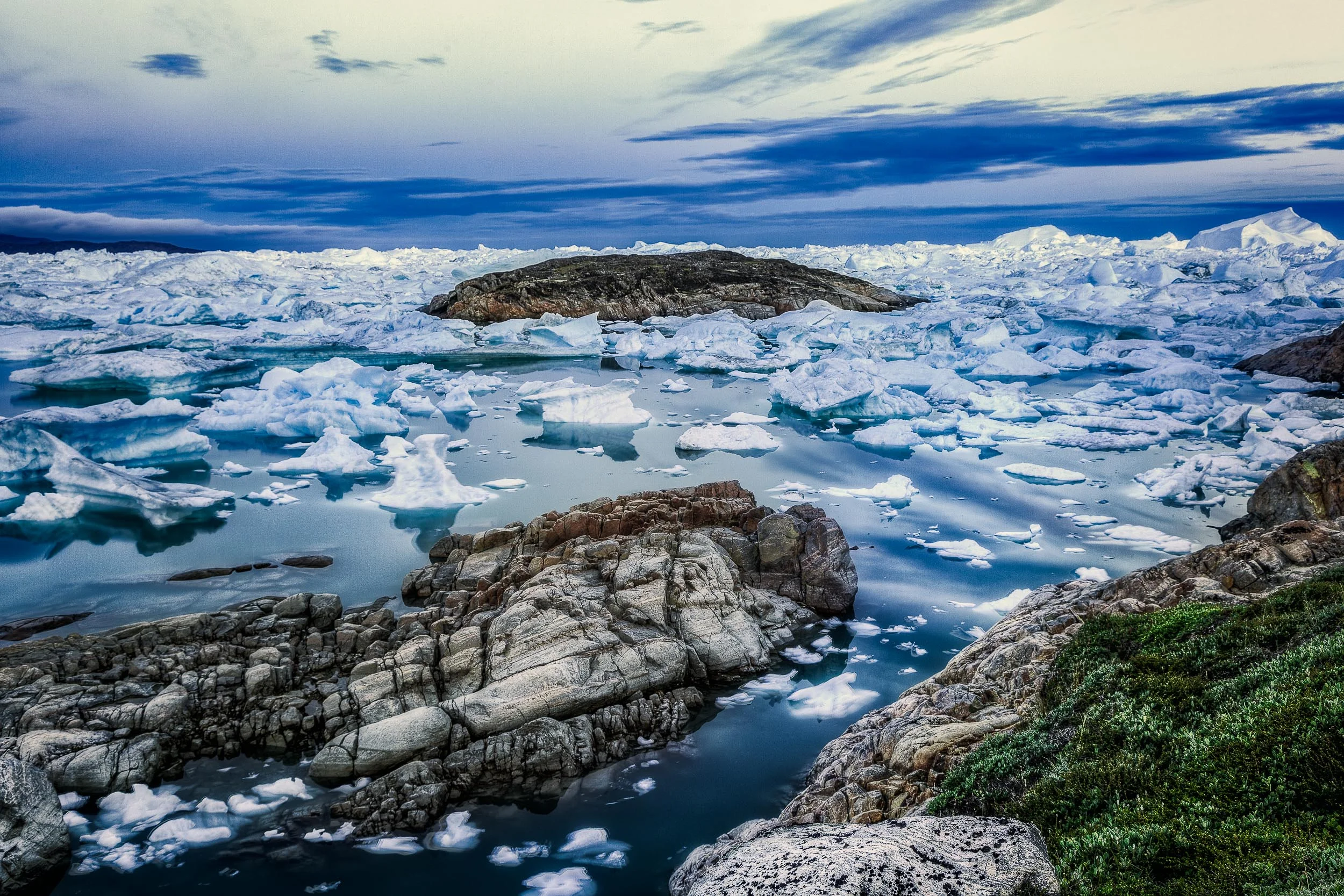 A stunning view of rock and ice on the edge of the Ilulissat Icefjord, Greenland .