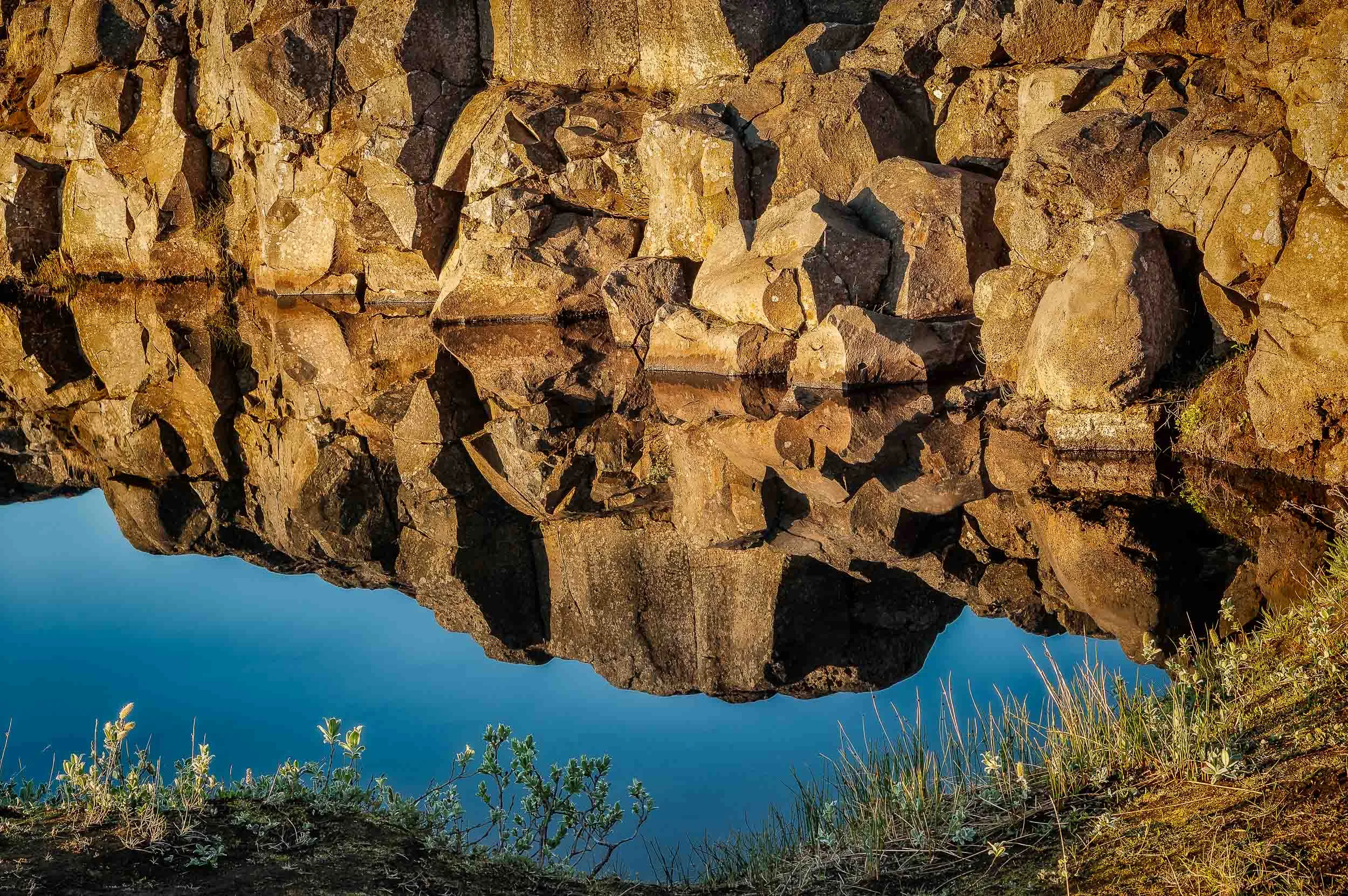 I found this beautiful, still pool of water on a walk in rural Iceland . The golden colors of the rocks contrasted wonderfully with the blue of the water.