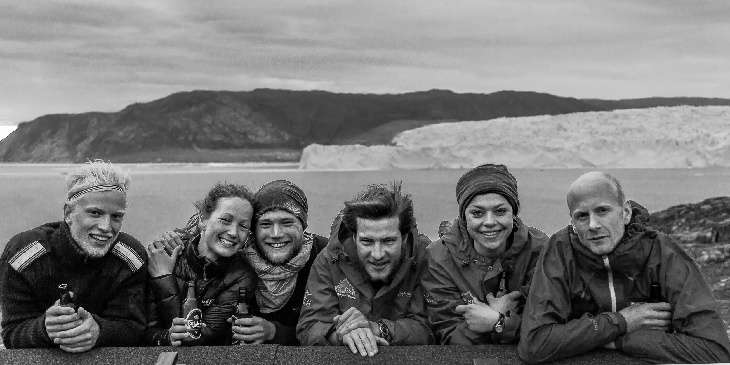 Group portrait of people in the landscape at Eqi Glacier in Greenland.