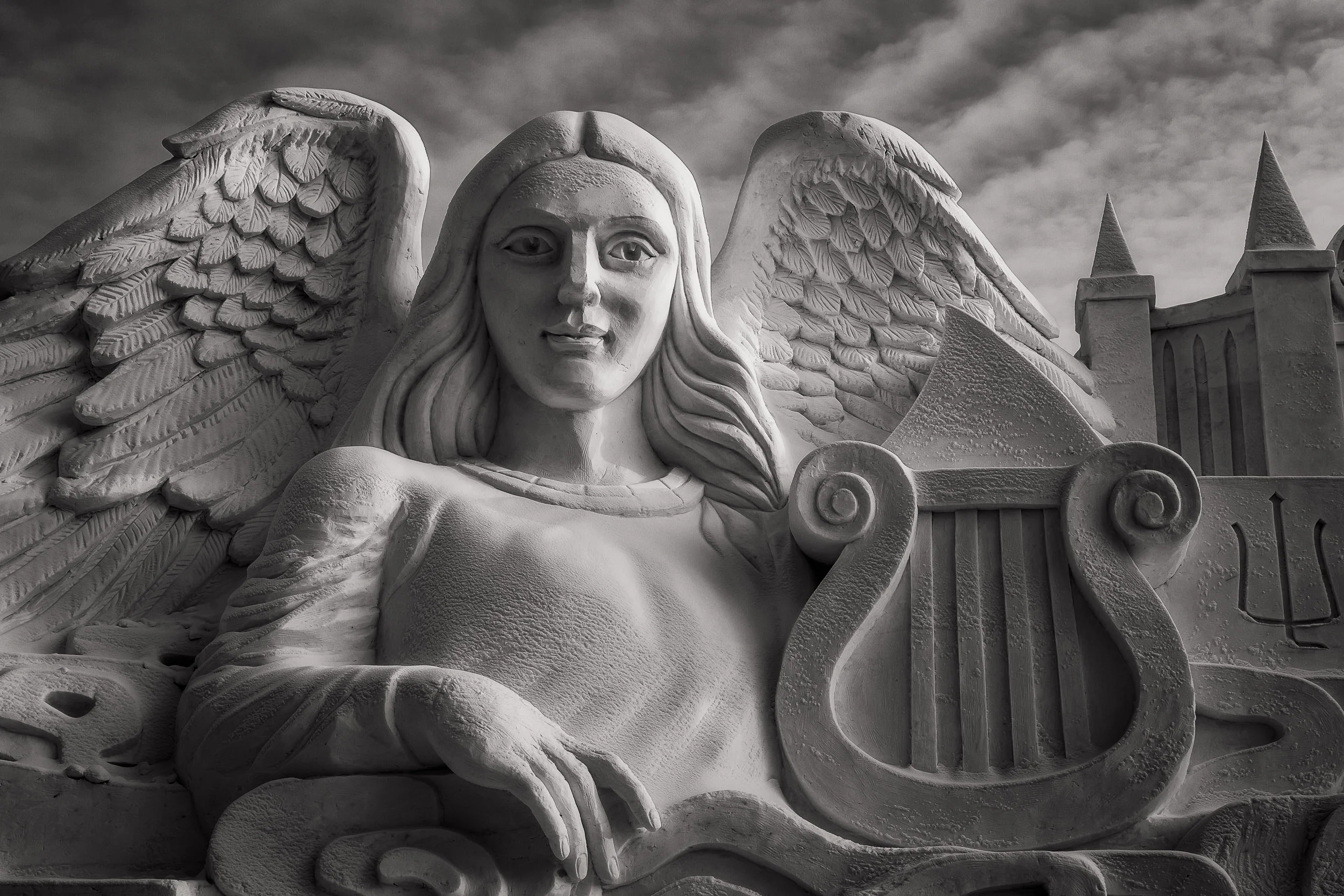 A wonderful sculpture of an angel and harp at the Harbin Sun Island International Snow Sculpture Art Expo in Harbin, China .
