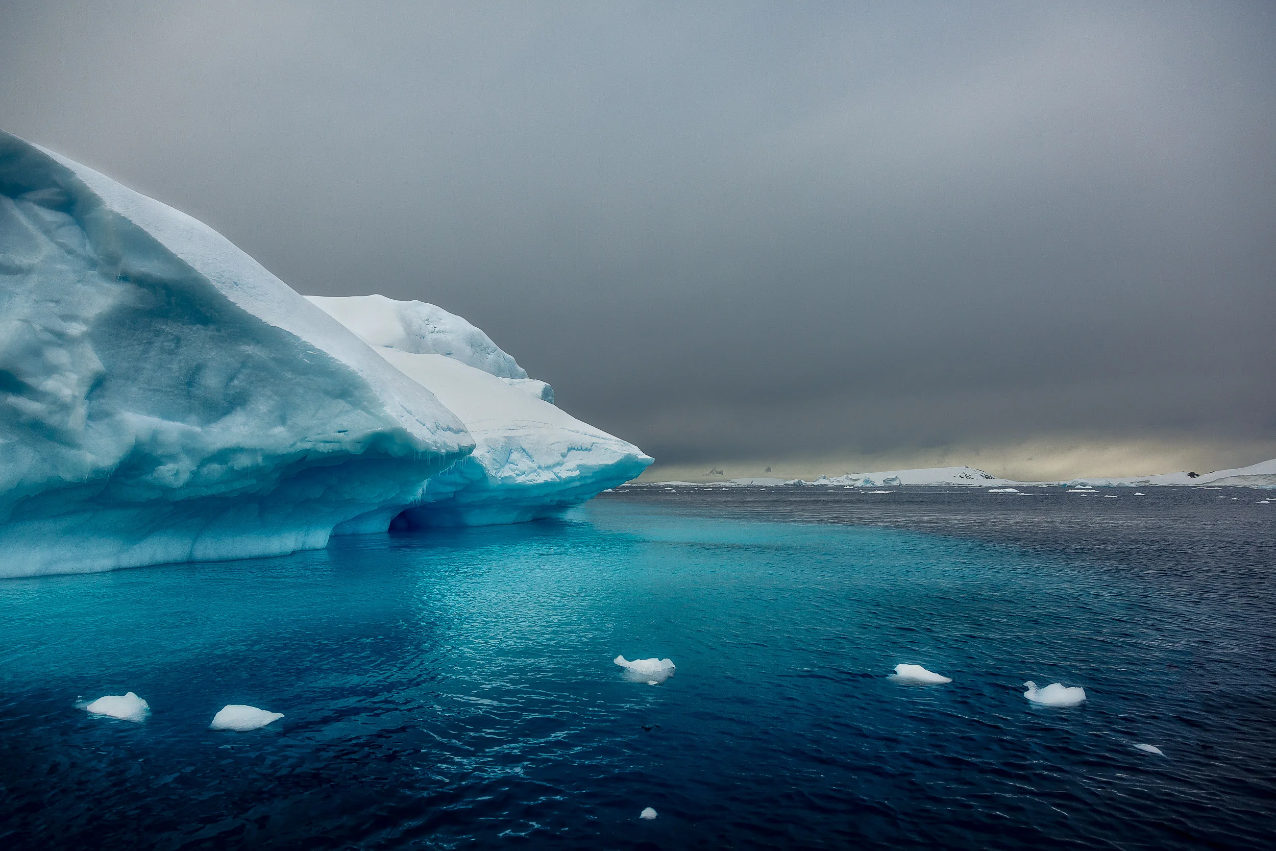 Light illuminates ice off the coast of Cuverville Island in Antarctica .