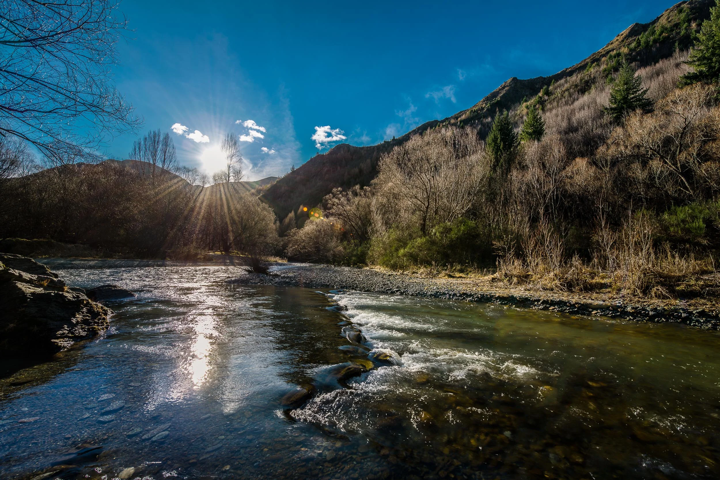 A view of the picturesque Arrow River on a winter's day in Arrowtown on the South Island of New Zealand .