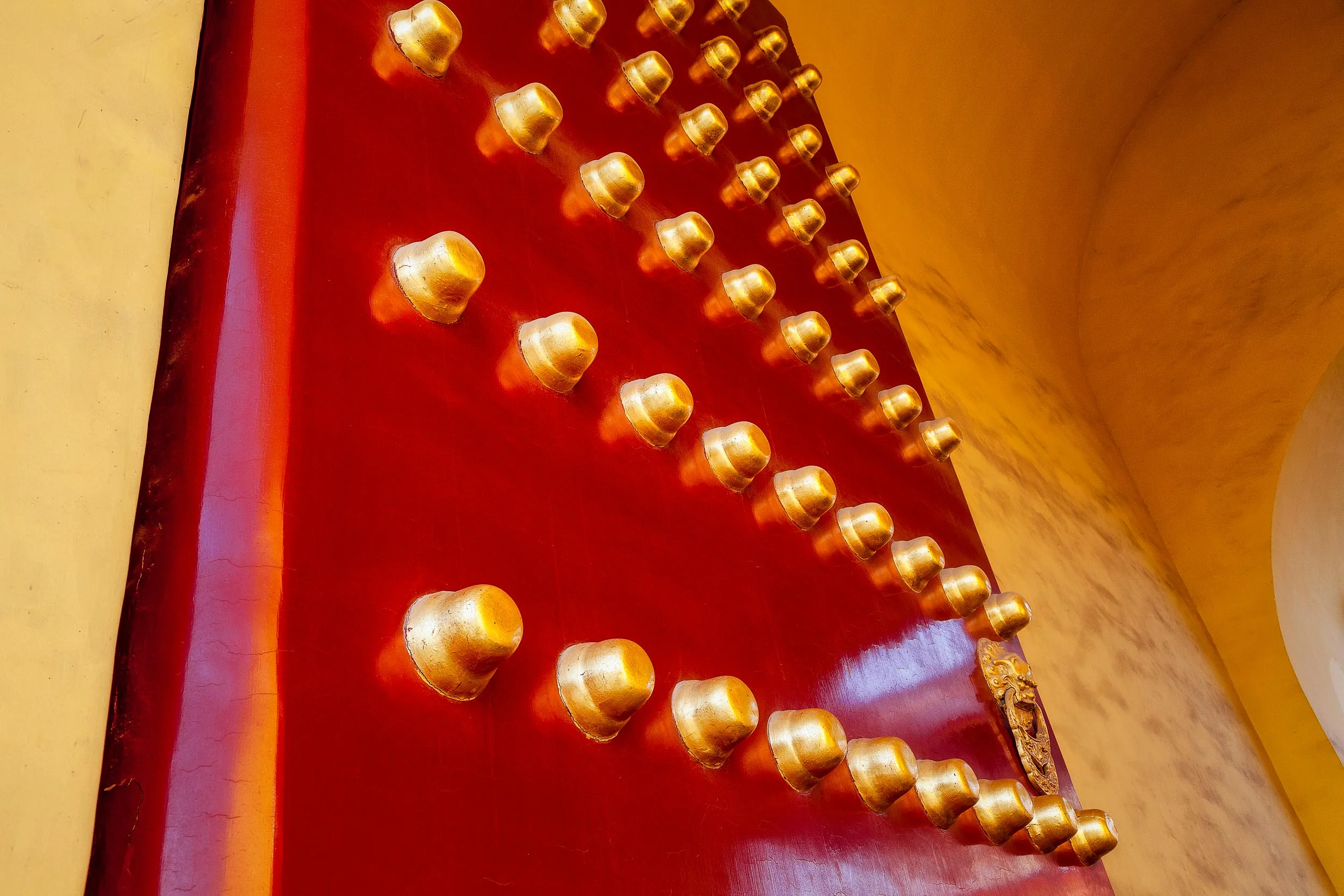 A massive red door adorned with big, brass studs is just one of the sites you’ll find photographing China in the grounds of the Forbidden City in Beijing, China .