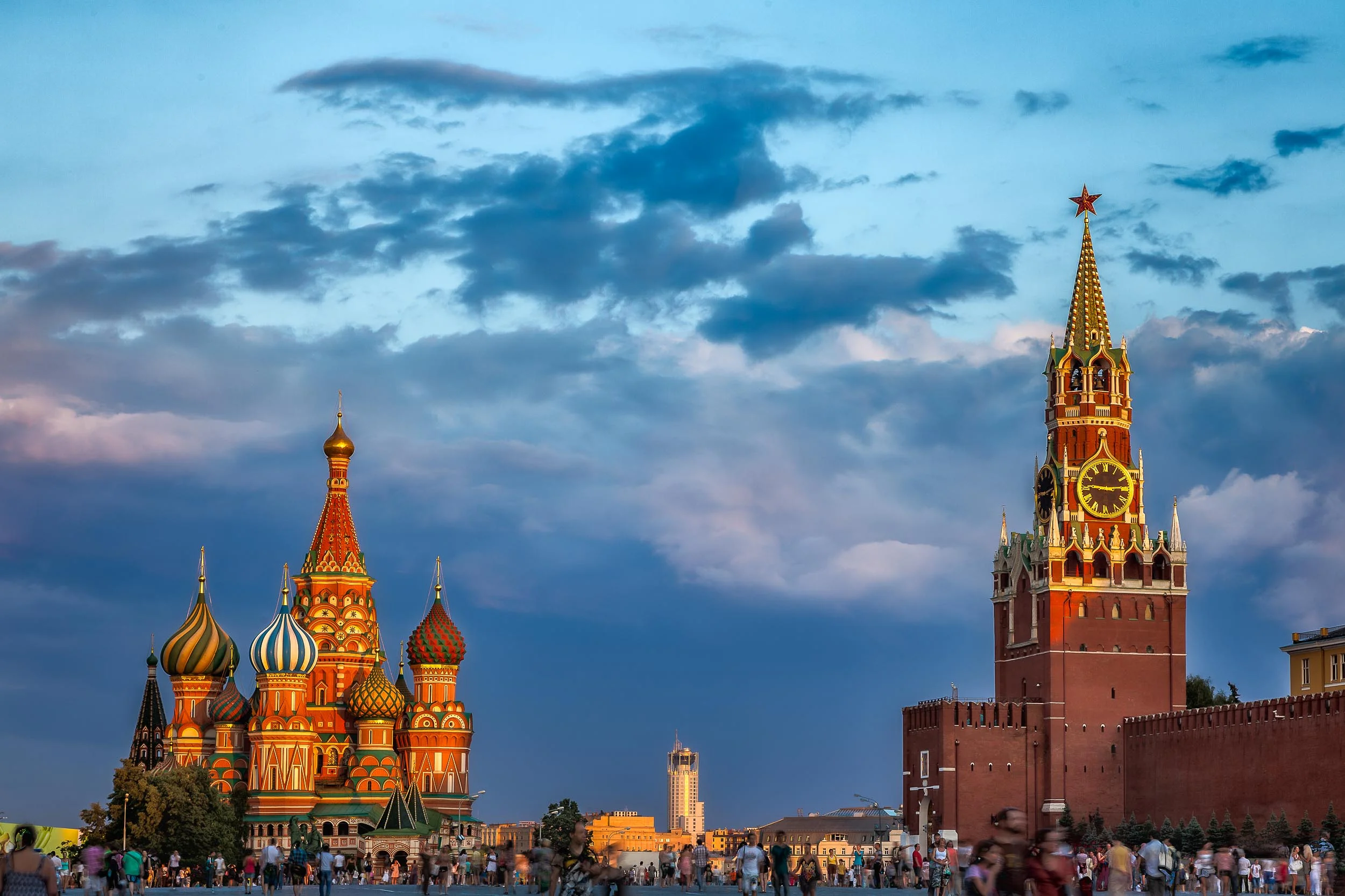 Warm sunset light illuminates the Kremlin and St. Basil's Cathedral in Red Square, Moscow .