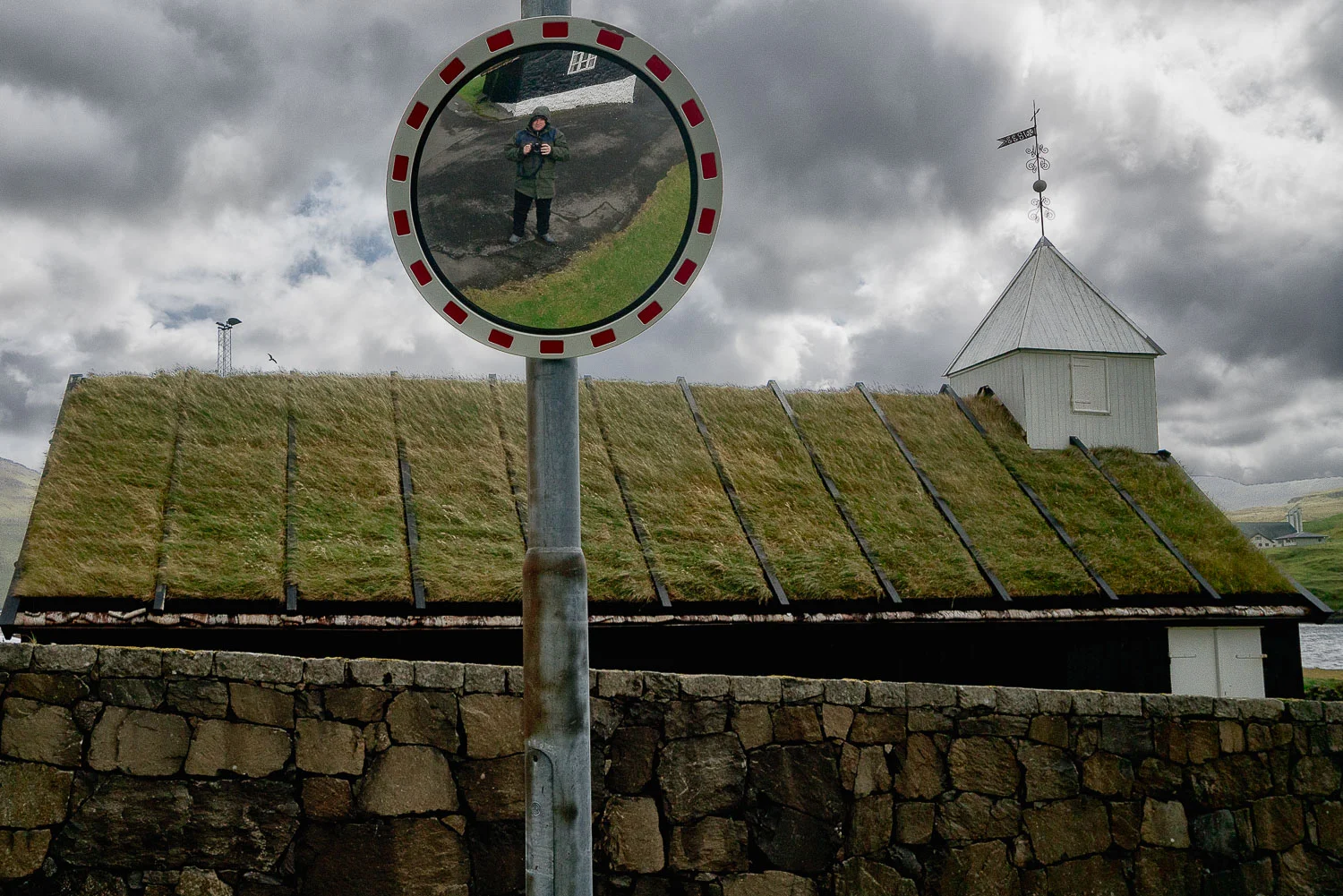 A self portrait of Glenn Guy , the Travel Photography Guru , in the village of Nordragota in the Faroe Islands .