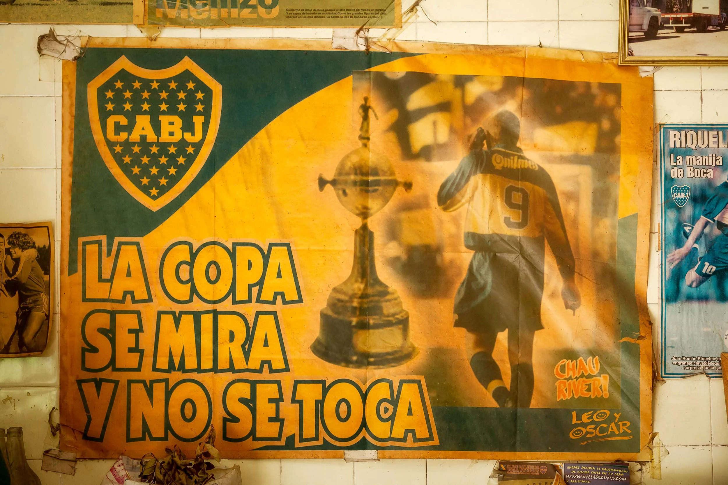 A faded football poster on a cafe wall in the La Boca tourist precinct of Buenos Aires, Argentina .