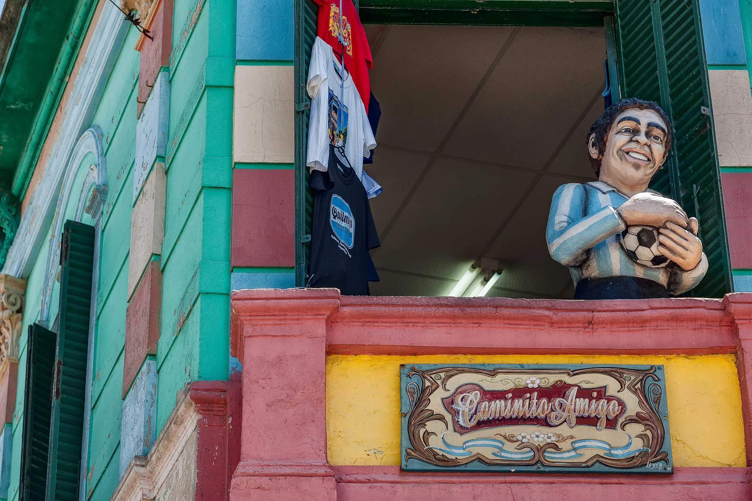 A statue of football legend Diego Maradona on a balcony in the La Boca precinct of Buenos Aires, Argentina .