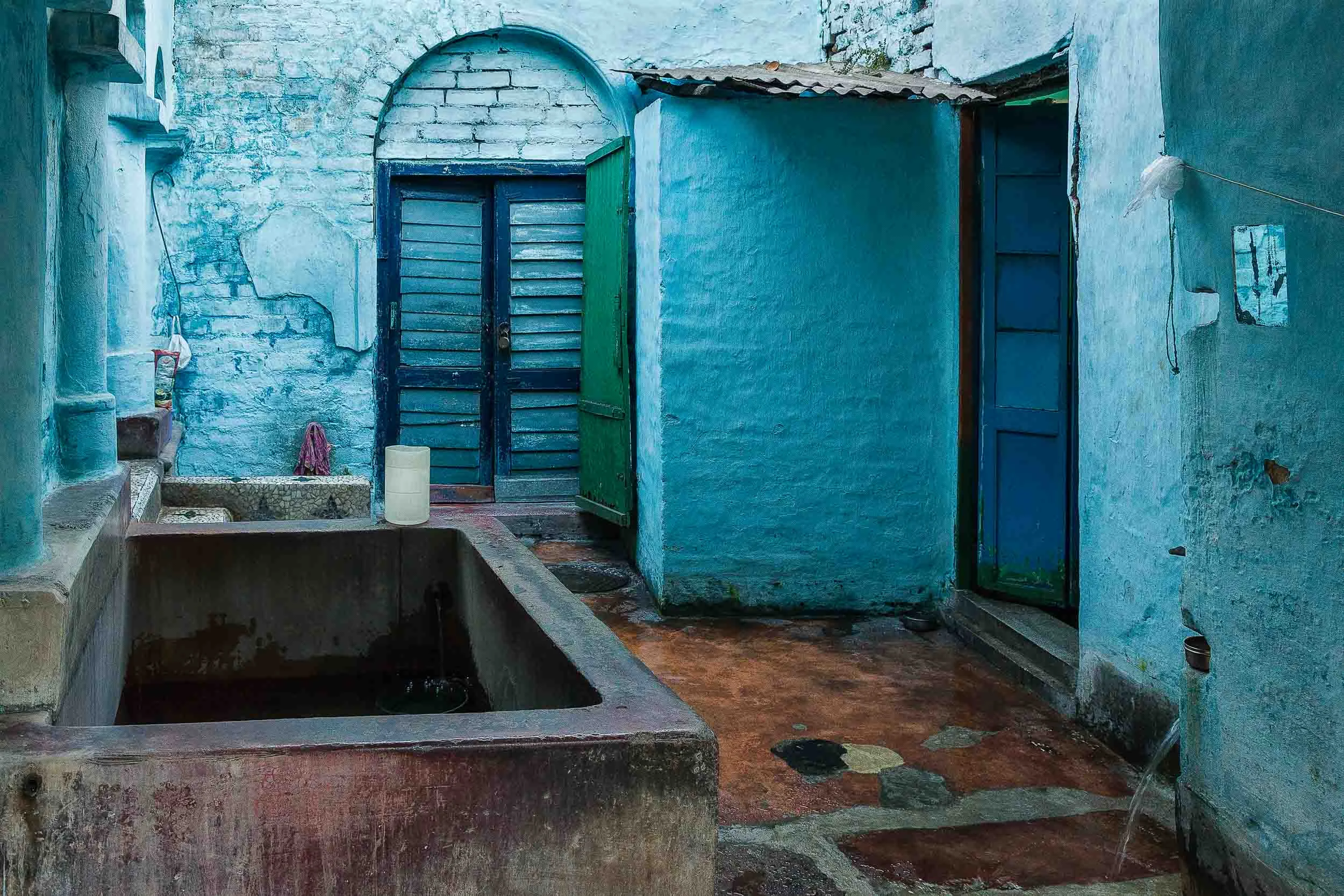 The colors blue and aqua dominate this household courtyard in Kolkata, India .