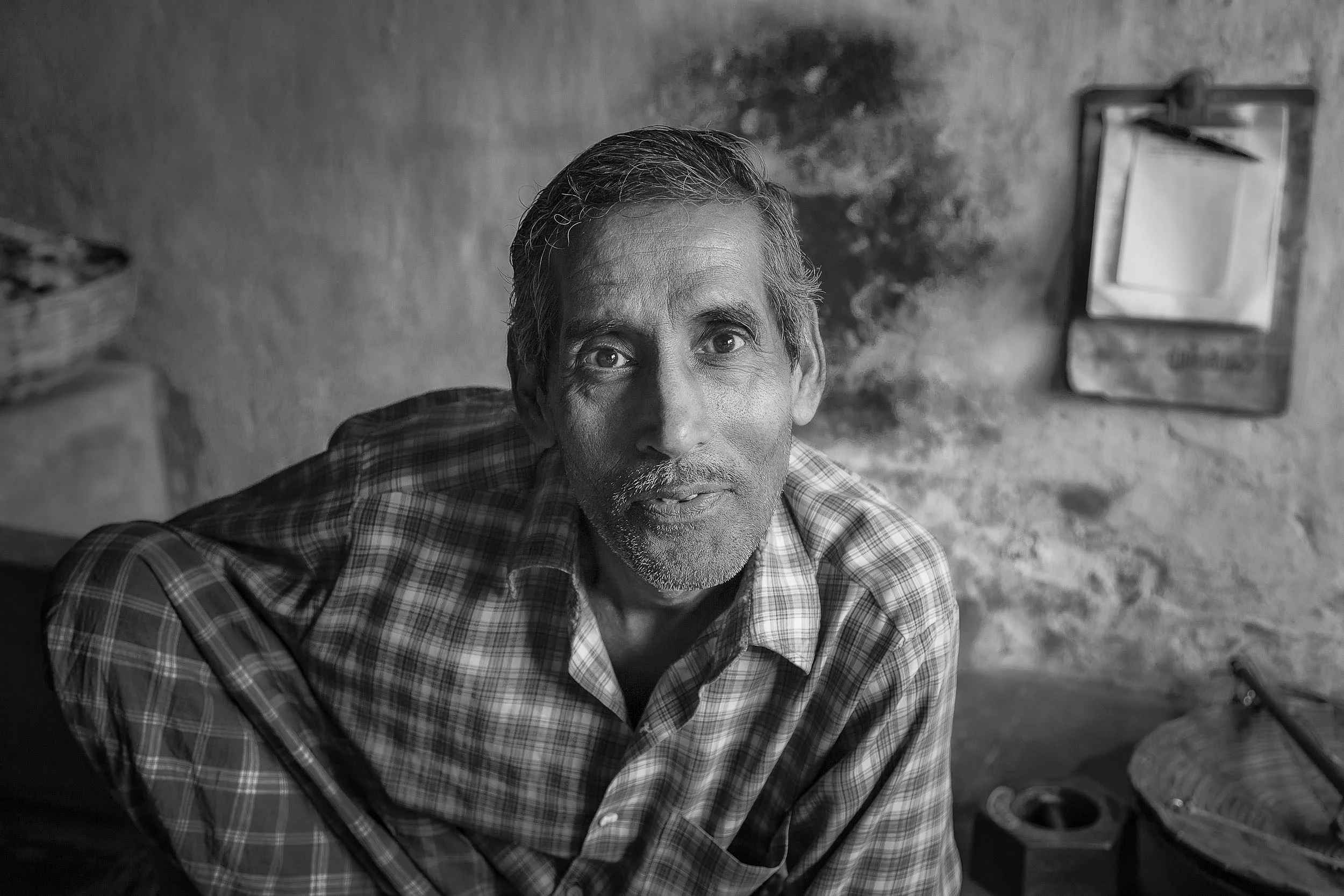 Street photo portrait of an interested soul in his workshop, Kolkata, India.